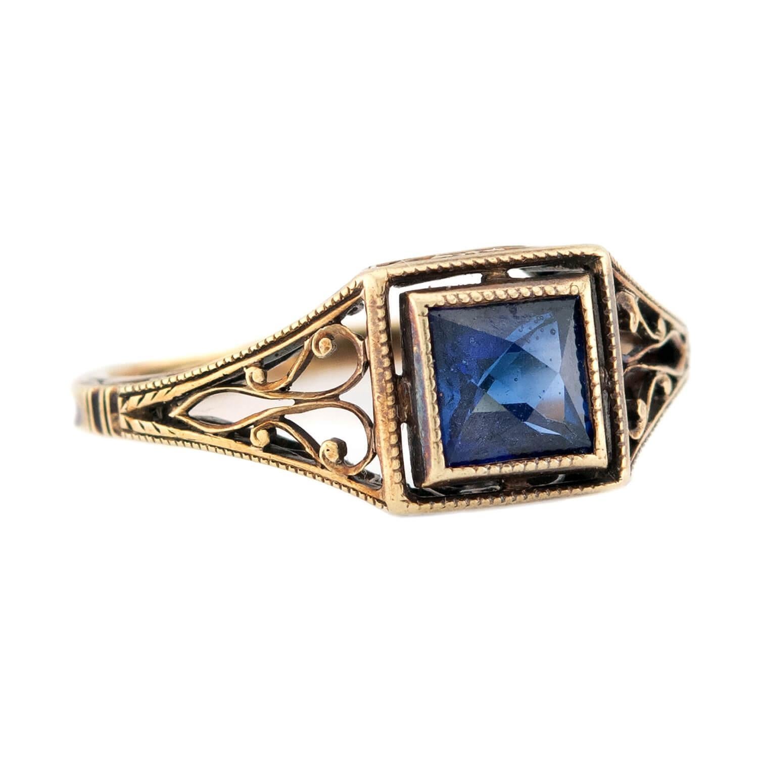 A dainty sapphire ring from the Art Deco (ca1920s) era! Crafted in 14k gold, this ring features a solitaire French cut sapphire. The sapphire, which has an approximate total carat weight of .65ct, is held within a milgrained bezel-setting and