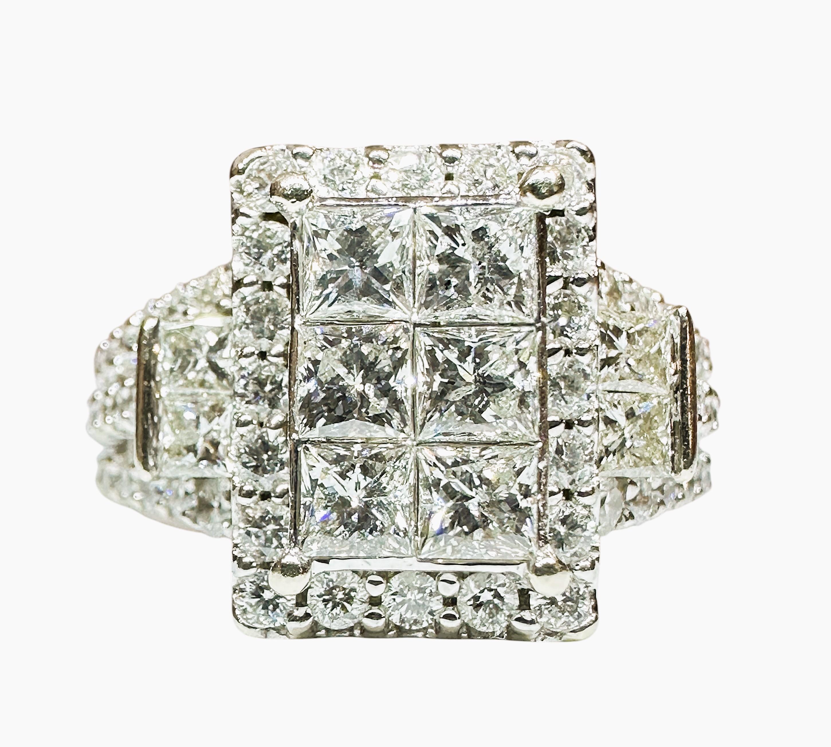 This is just an amazing ring!!  It is pre-owned but as you can tell from the photos it has very minimal signs of wear and is in excellent condition.  There are 13 Princess Cut Diamonds measuring 3 x 3 mm on the front of the ring.  Also on the front