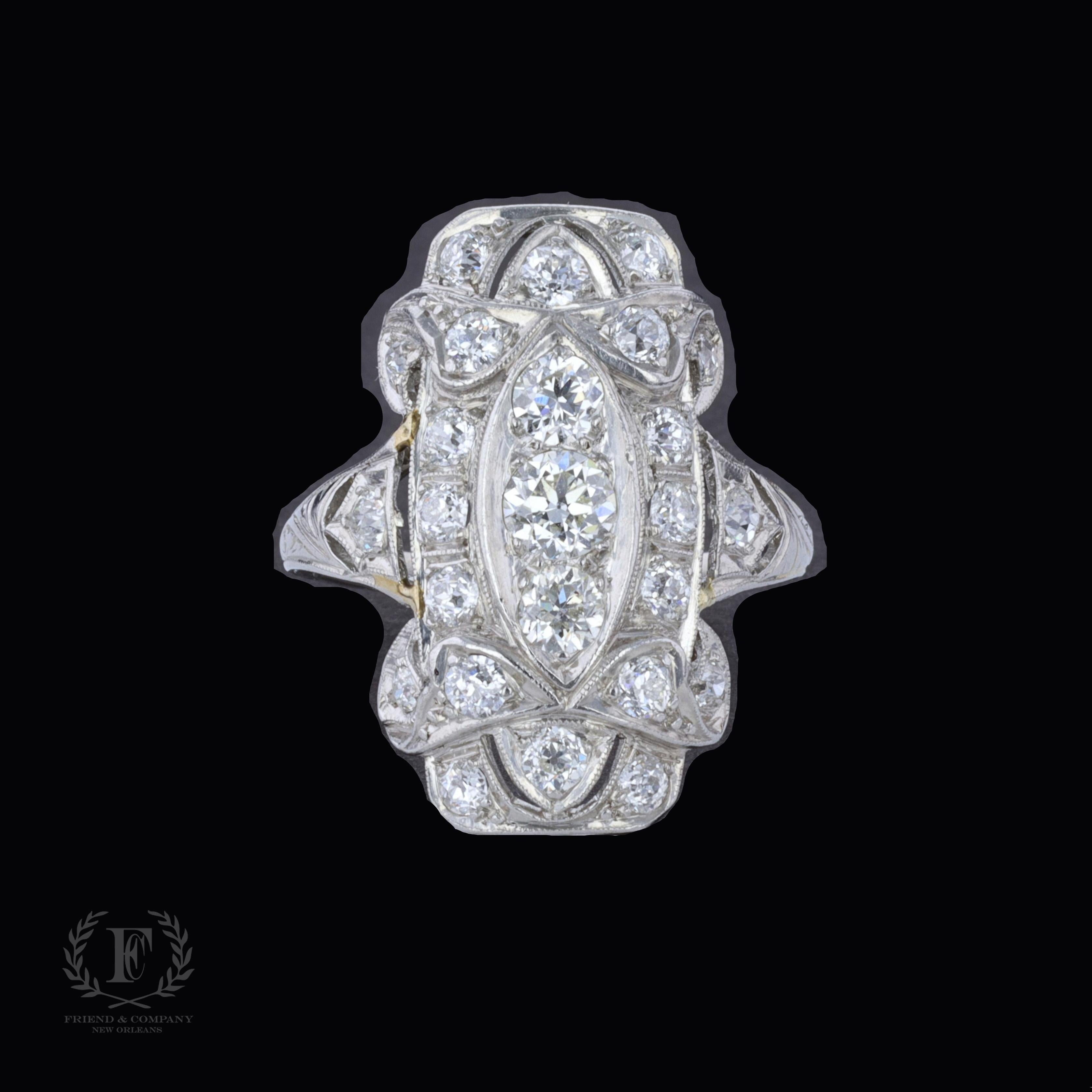 This Art Deco ring is centered with a beautiful old mine cut diamond that weighs approximately 1.03 carats. The color of the diamond is I-J, and the clarity is VS. The center stone is accentuated by two old mine cut diamonds that weigh approximately