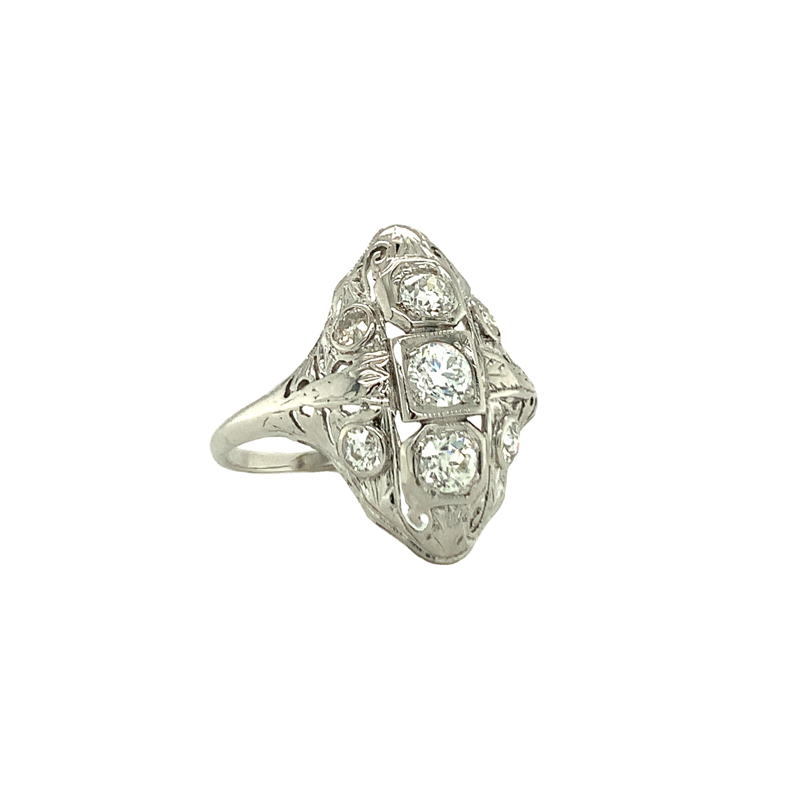 One Art Deco 14K white gold diamond filigree ring featuring seven bead set, old European cut diamonds totaling 0.64 ct. with L-M color and SI-1 clarity.  Measures 22 mm. long upon the finger.  

Vintage, hand-made, exquisite.  

Metal: 14K White