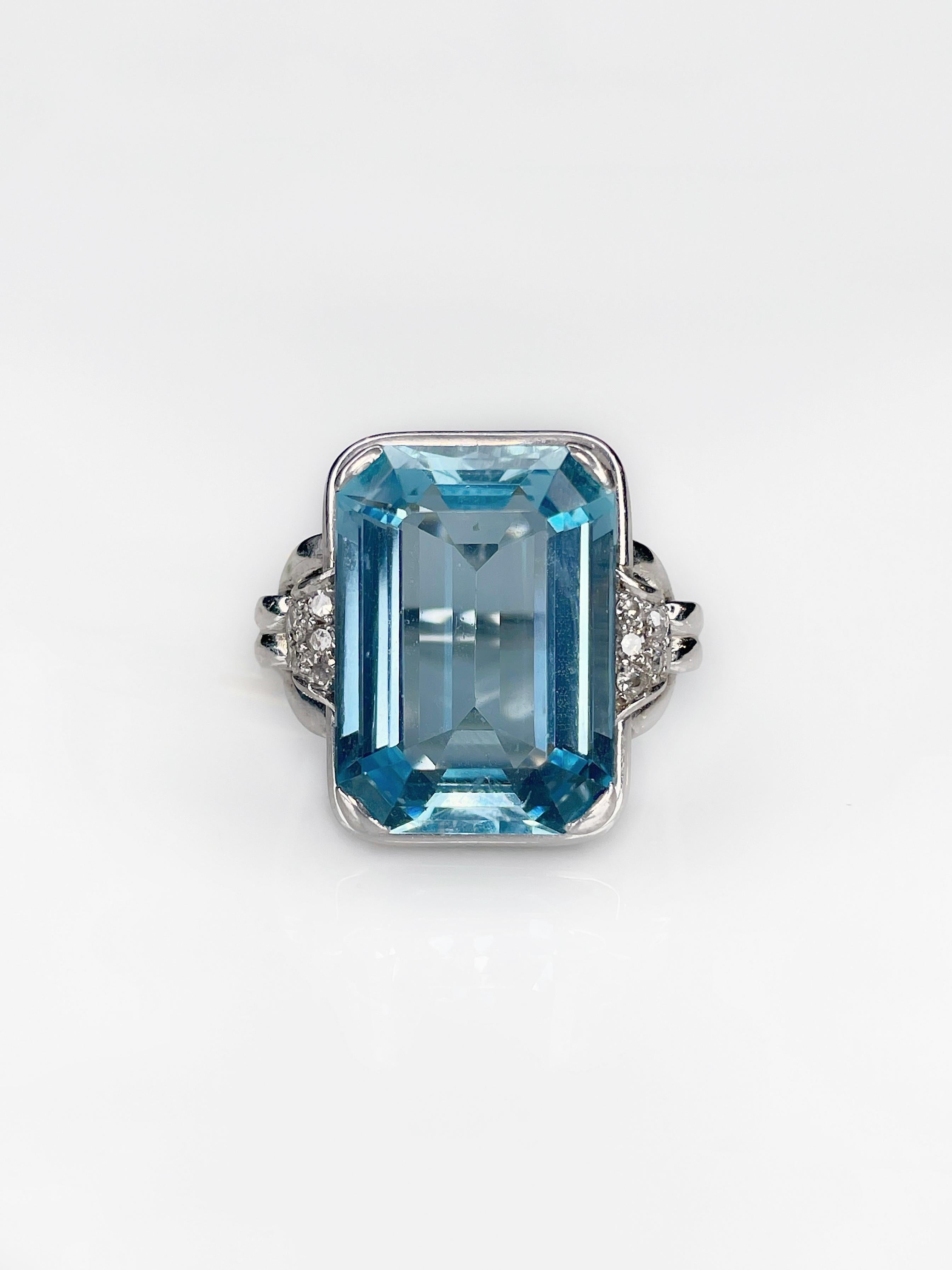 This is a magnificent Art Deco style modern cocktail rectangular ring crafted in 14K white gold. It boasts an exceptional Emerald cut Aquamarine which is 14.75ct (13x19mm), colour - very slightly greenish blue (vslgB 3/2), clarity - VS. The gem is