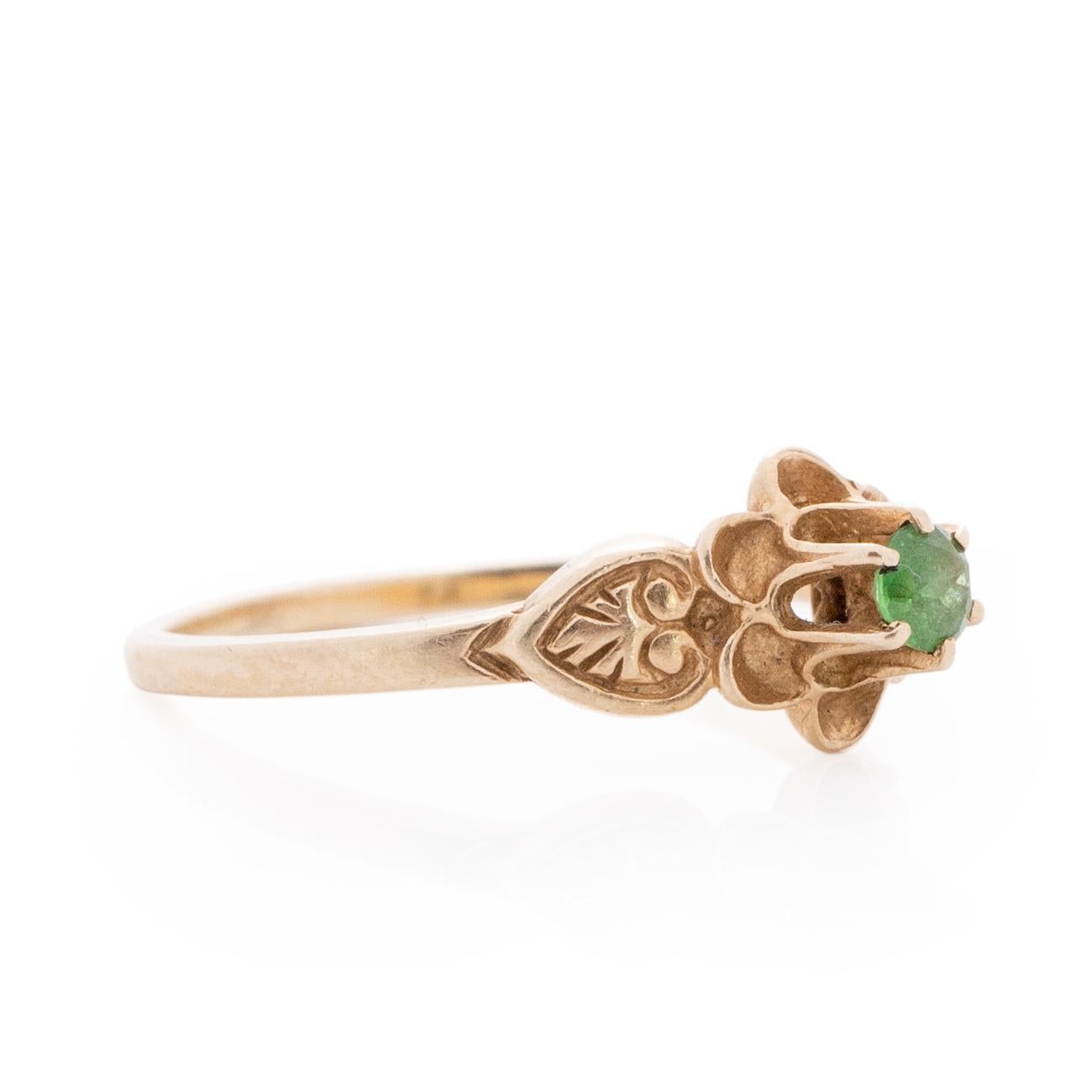 Here we have a elegant Art Deco Solitaire flower Emerald ring. The emerald solitaire is held by 6 sharp talon prongs, set in a beautiful flower design. Along the shanks are clean and crisp leaf carvings tying the whole floral theme together. This