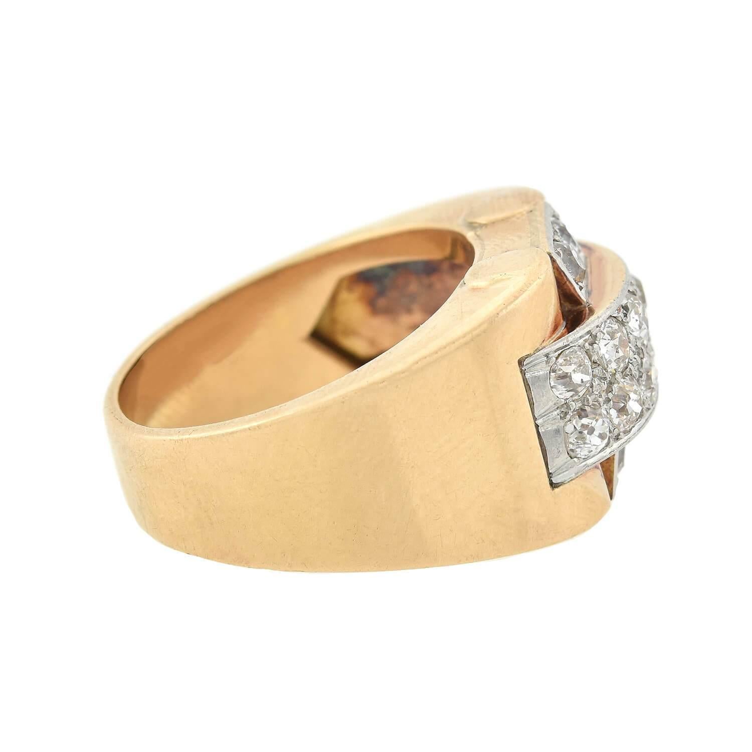 A fabulous and bold ring from the Art Deco (ca1930s) era! Crafted in rosy 14kt yellow gold, this ring boasts a platinum-topped bridge of diamonds. 16 Old Mine Cut diamonds decorate the overlapping pattern, displaying approximately 1.50ctw of I/J