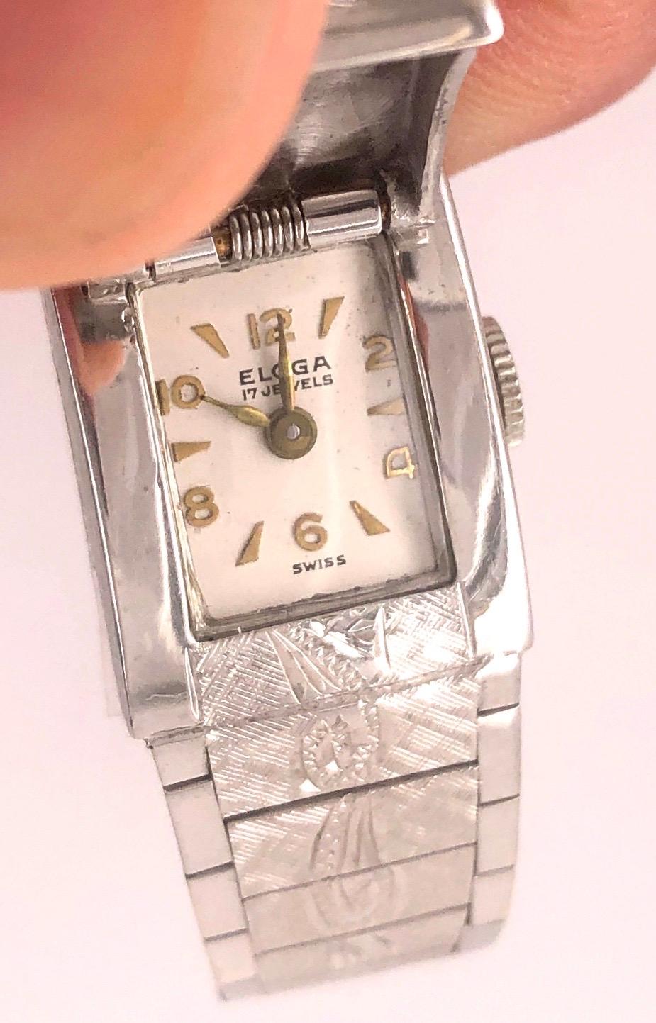 14Kt Whtie Gold Eloga Ladies Wrist Watch w. 17 Jewels 21.6 grams weight without works. Eloga Watch Company Swiss Made. The watch having closed cover face with a center diamond. 
The company began in 1917 when Fritz and Hans Spahr set up a