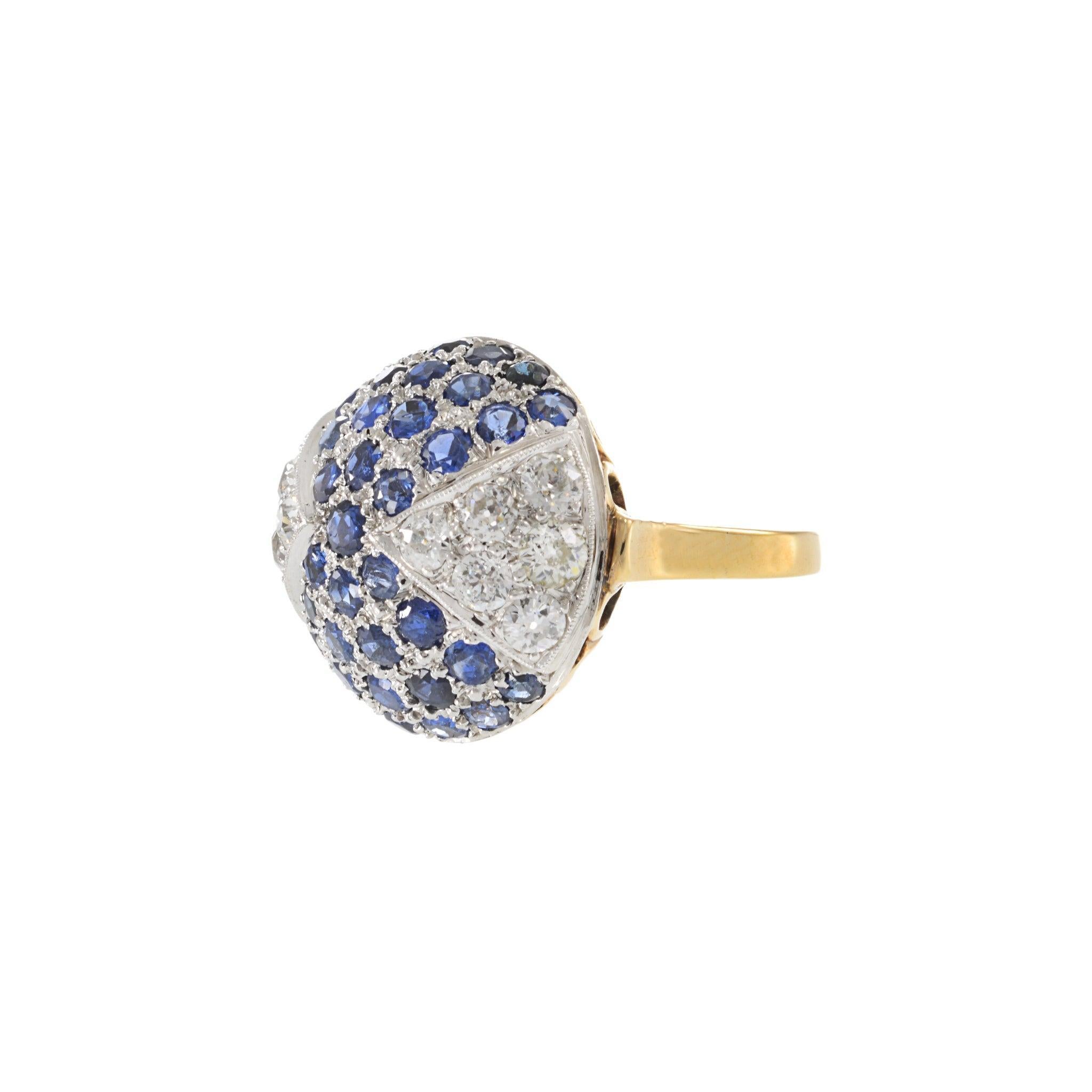 This estate dome ring channels the geometric elegance of the Art Deco period with bold curvature and gemstone precision. Crafted in 14KT yellow gold with a platinum top, it features a checkerboard-style dome pavé-set with 2.80 carats of vivid round