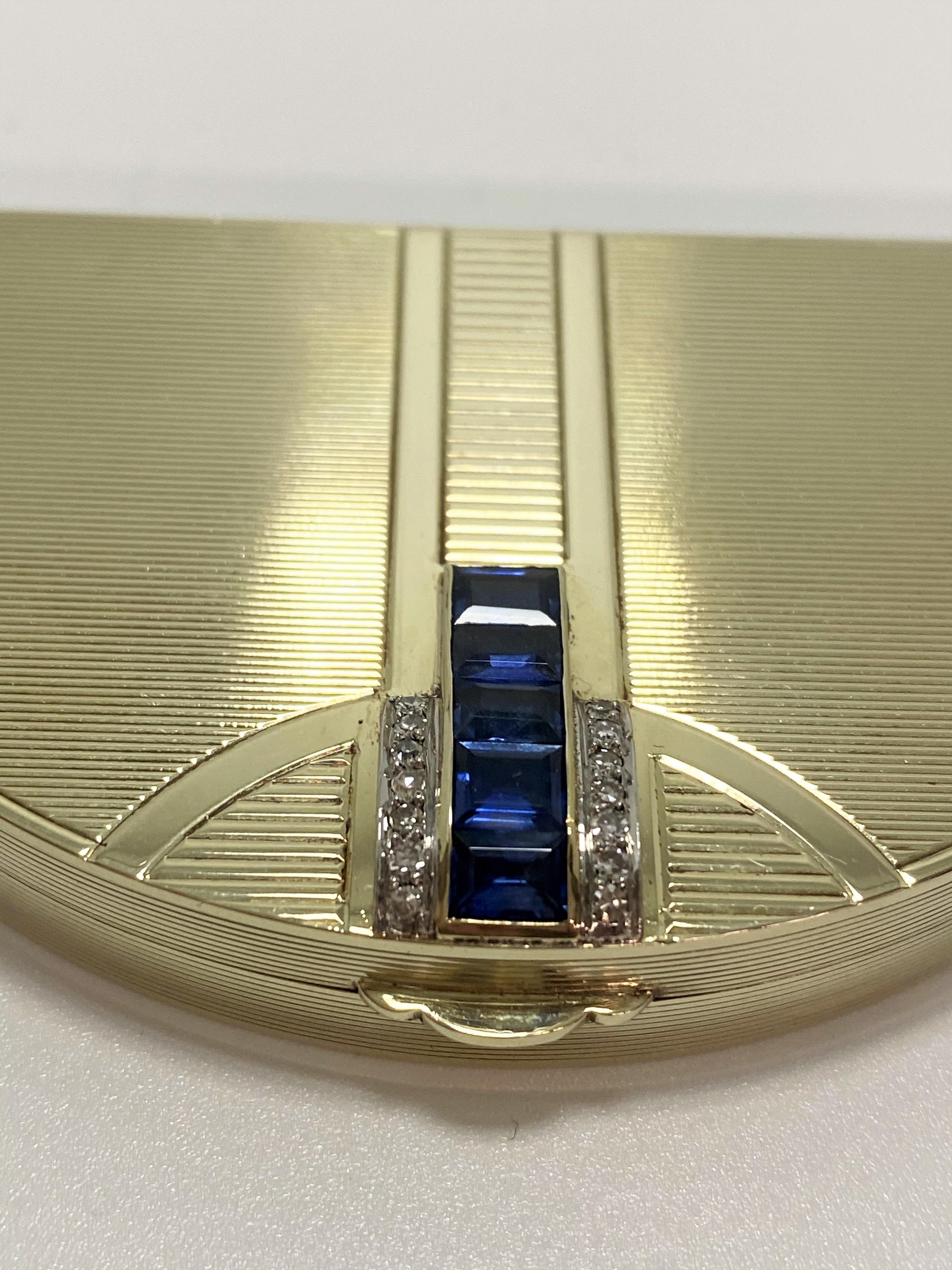 Antique Art Deco 14k yellow gold French powder compact. Compact is adorned with 5 square blue sapphires totaling  2.14 carat total weight and 0.07 carat total weight of single cut diamonds H color and SI1 clarity.  Compact is half moon shaped and