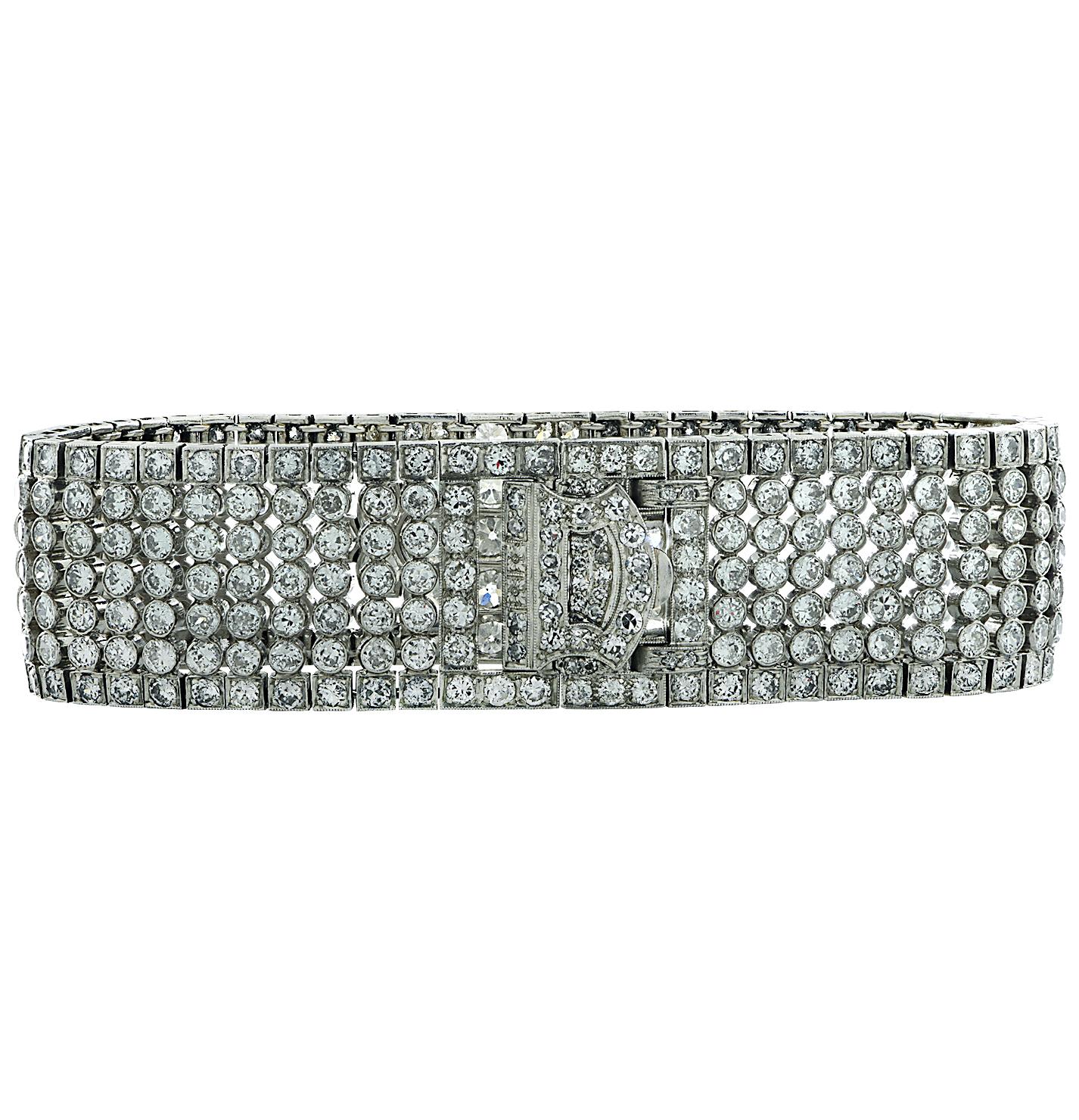 Spectacular Art Deco bangle bracelet crafted in platinum featuring round brilliant cut diamonds weighing approximately 15 carats total, G color, VS clarity. Diamonds, meticulously bezel set and detailed with milgrain, are arranged in a fine open