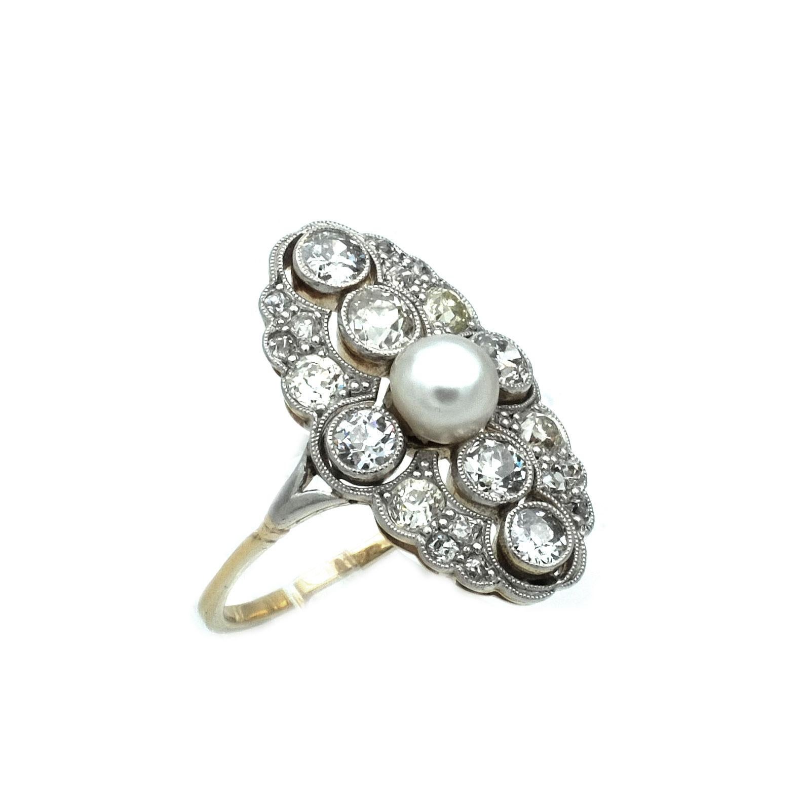 Art Deco 1.5 Carat Diamond Pearl Gold and Platinum Ring, circa 1915

Very elegant ring with an oval ring head, pierced, set with one natural pearl in the center surrounded by 6 larger diamonds in a bezel setting, the edges set with further diamonds