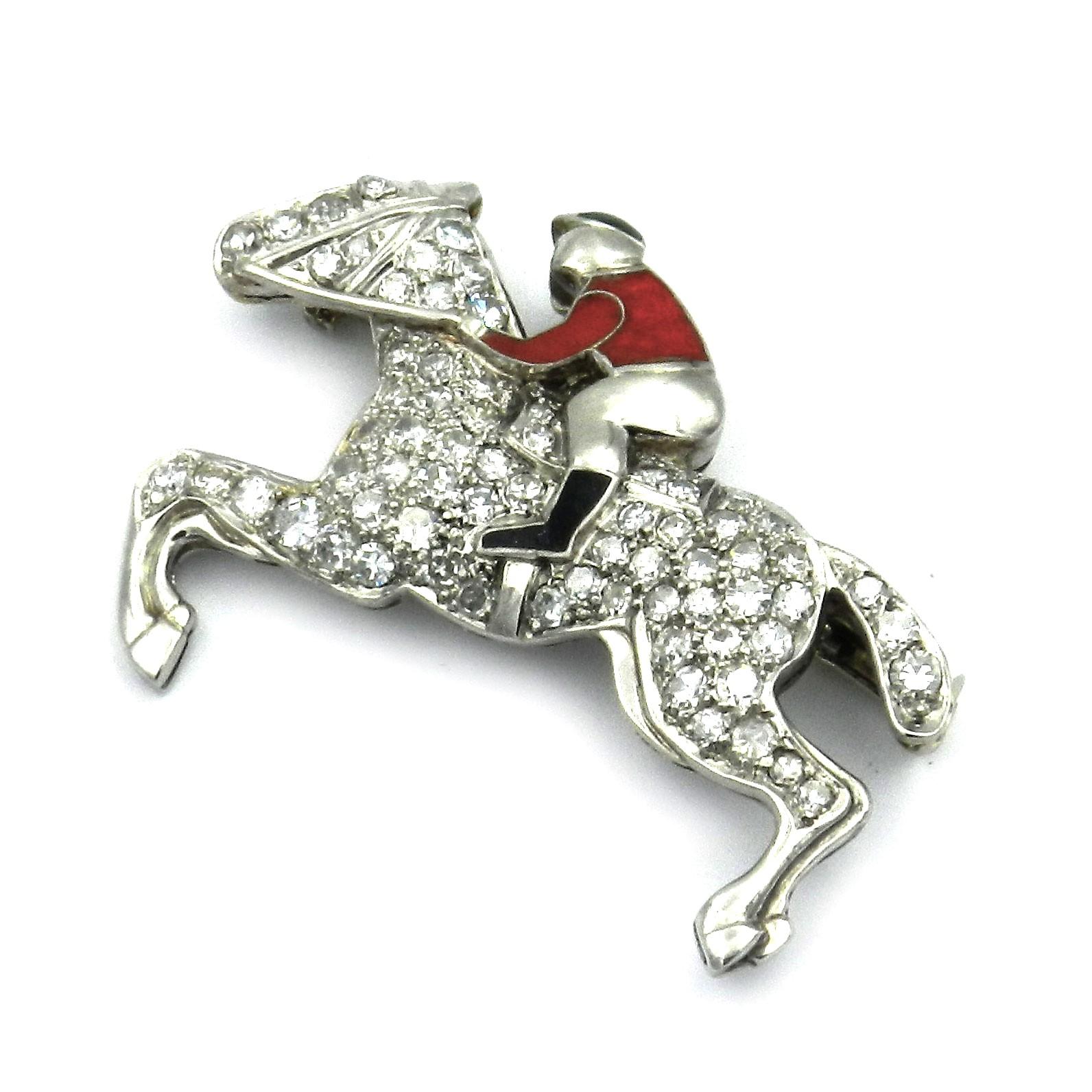 Art Deco 1.5 ct Diamond and Enamel Jockey Platinum Brooch, circa 1920

This rare diamond brooch in the shape of a galloping horse with a jockey is made of platinum. The horse's body is pavé set with 64 old cut diamonds, the jockey's jersey is