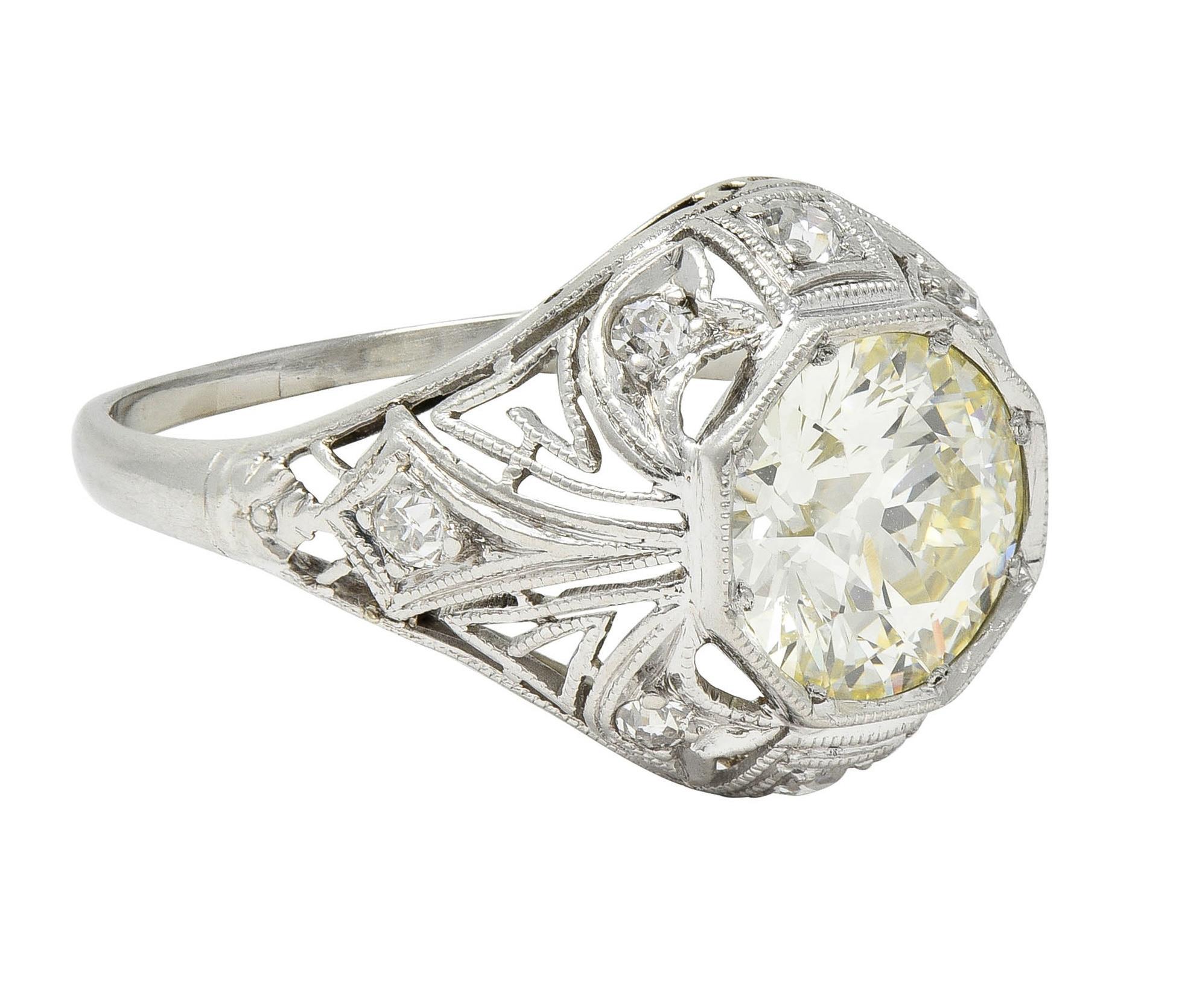 Centering an old European cut diamond weighing approximately 1.42 carats  - M color with VS1 clarity
Bead set in an octagonal form head with a pierced ivy and Greek key motif surround
With single cut diamonds weighing approximately 0.18 carat