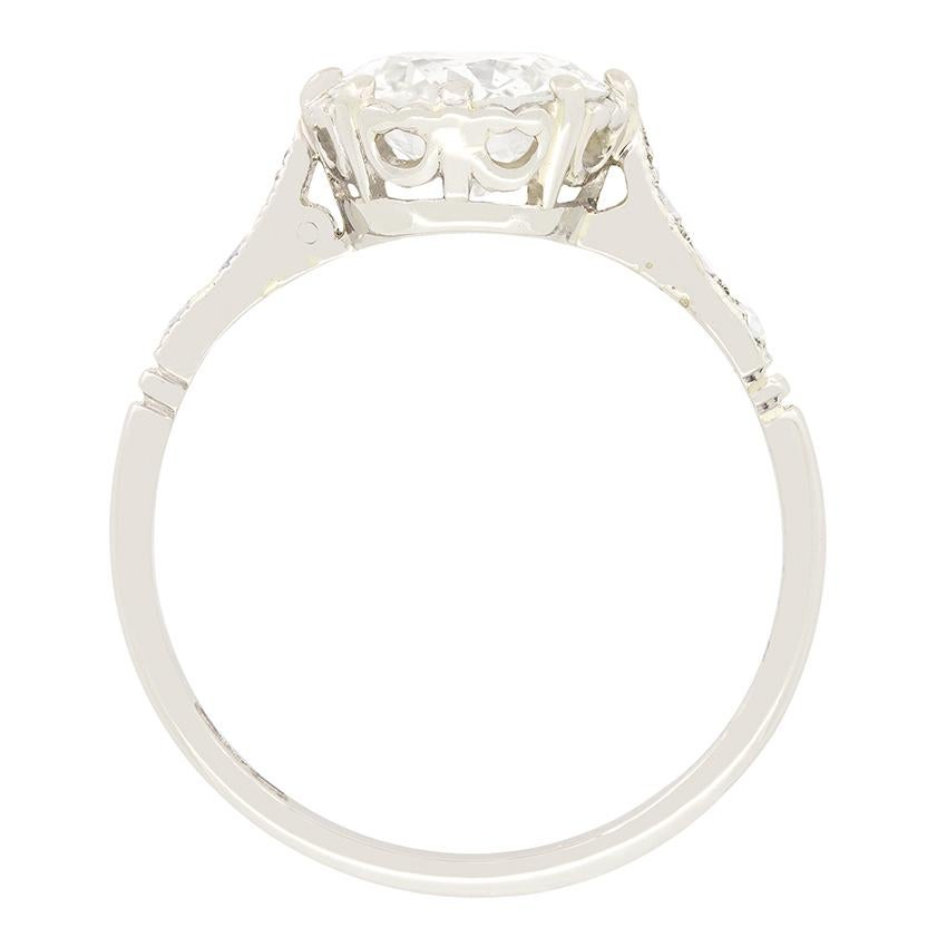 A stunning old cut diamond takes centre stage in this classic solitaire ring dating back to the Art Deco period. The diamond has a weight of 1.50 carat , with a colour of H and clarity of SI2. Down each shoulder an additional three old cut diamonds