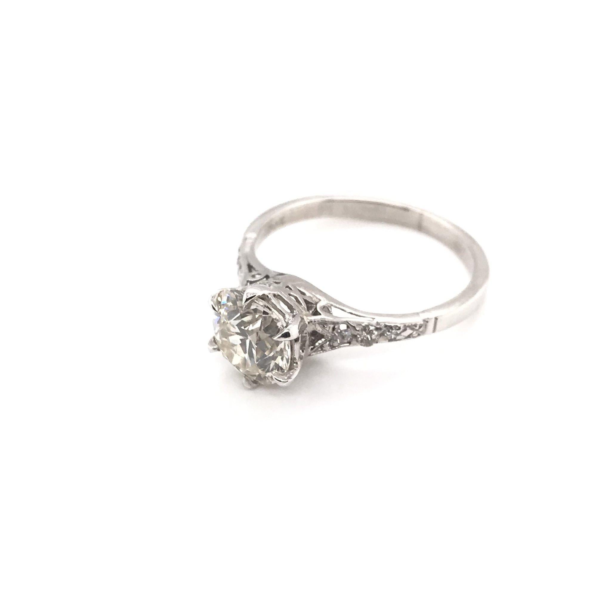 This antique piece was handcrafted sometime during the Art Deco design period ( 1920-1940 ). The platinum solitaire style setting features a beautiful 1.54 carat center diamond. The center diamond grades approximately L in color and VS1 in clarity.