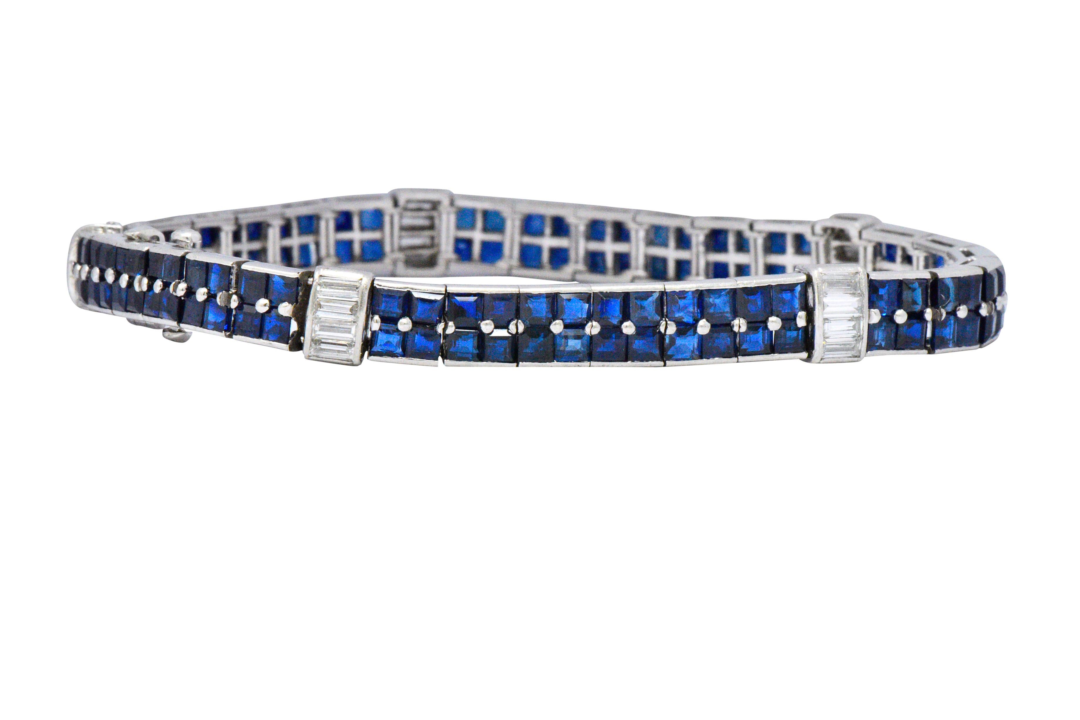 Set with 120 square cut natural sapphires, weighing approximately 14.50 carats total, bright deep blue and well matched

Accented by channel set baguette cut diamonds, weighing approximately 1.10 carats total, G/H color and VS to SI clarity

With a