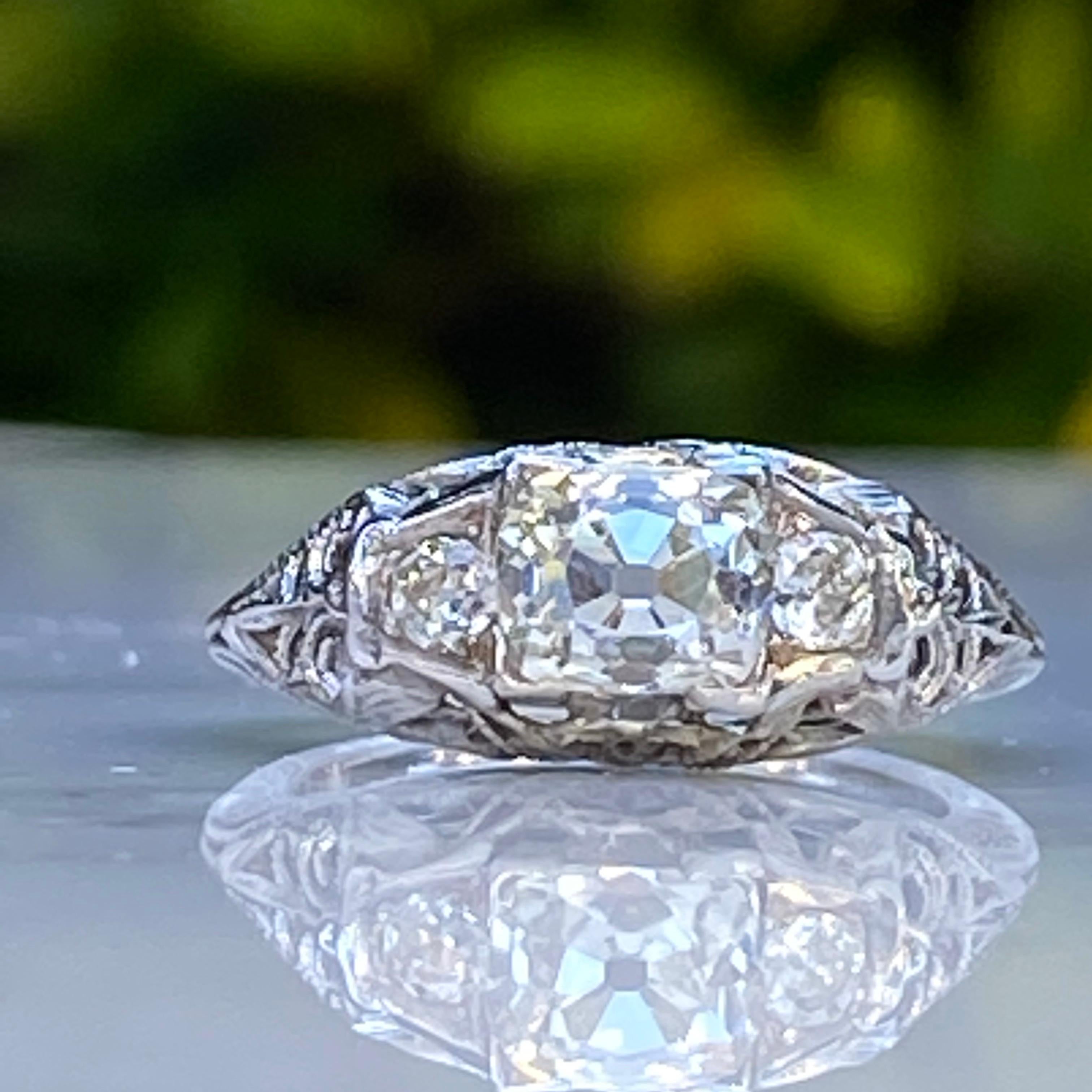 Details:
Fantastic 18K white gold filigree 1.37 carat old mine cut diamond ring from the 1920's! The filigree is intricate and delicate, and the ring has a great low profile setting. This ring comes with an appraisal.

Appraisal Notes:
Old mine cut