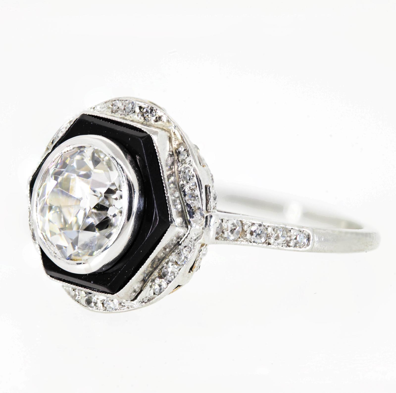 Hand created of platinum in the 1930s, this one of a kind beauty centers a sparkling 1.65 carat Old European cut Diamond - I/J color - SI1 clarity.  The diamond is surrounded by a hexagonal Onyx disc, making a stunning contrast to the white diamond.