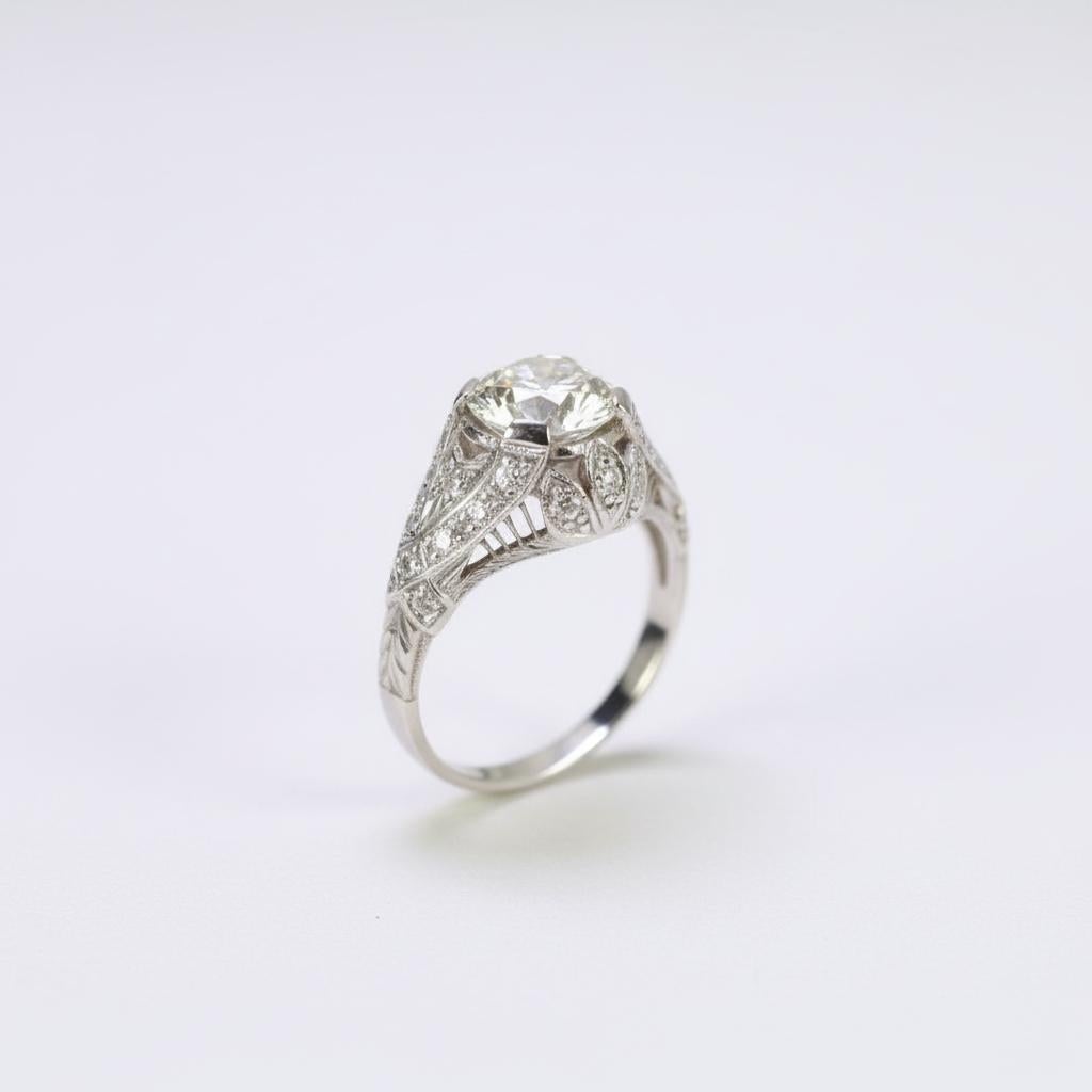 Cette bague de fiançailles en diamant vintage est une pièce époustouflante de l'artisanat Art Deco authentique, qui capture le romantisme et l'élégance des années 1920. La pièce maîtresse est un superbe diamant de 1,67 carat de taille européenne
