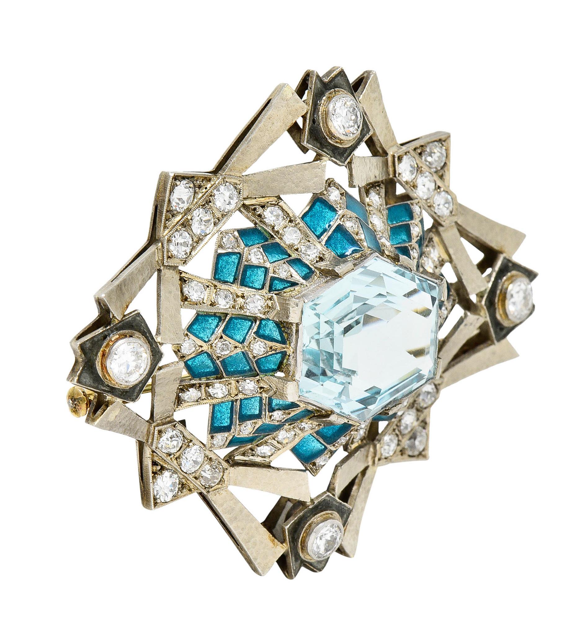 Substantial brooch is designed as a dimensional and geometric burst motif

Centering a hexagonal cut aquamarine weighing approximately 13.25 carats - greenish blue in color

Surrounded by a teal plique-a-jour design with no loss

With old European