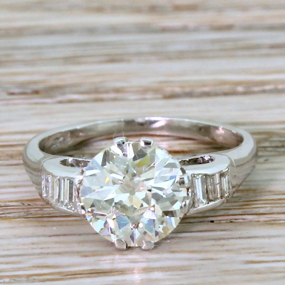 A mesmeric old cut diamond engagement ring. The old European cut diamond in the centre – graded by HRD Antwerp as L colour, VS2 clarity – displays the subtlest champagne hue and absolutely fizzes with life and fire. The stone is finely crafted