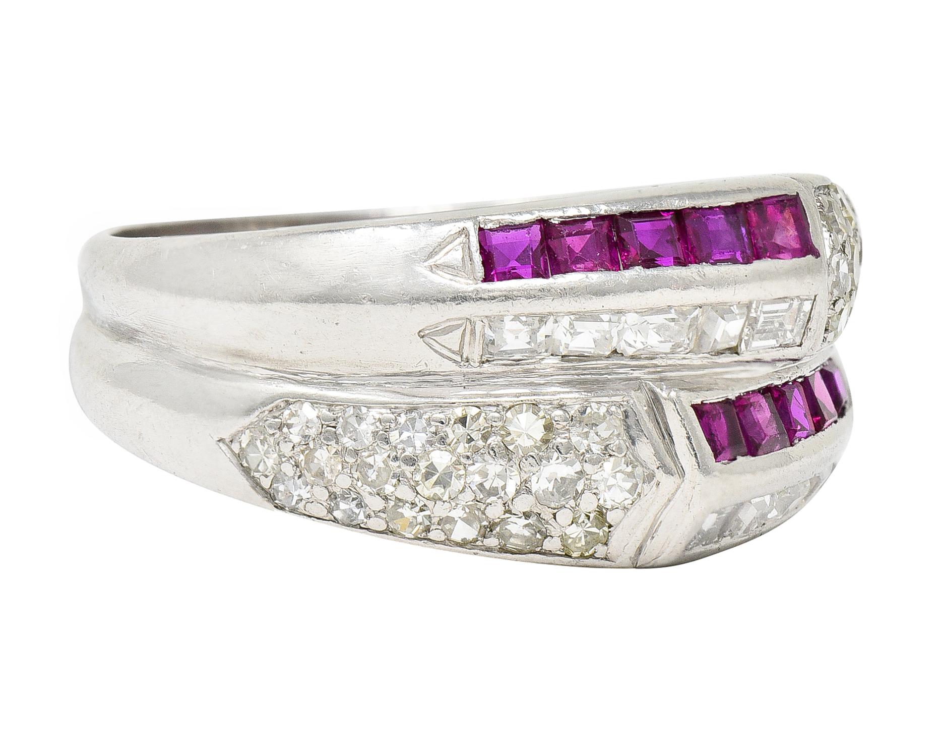 Ring is designed as two fused and deeply ridged band rings. With two rows of channel set square cut rubies. Well matched in purple red color while weighing approximately 0.60 carat total. Contrasting two rows of channel set step cut diamonds.