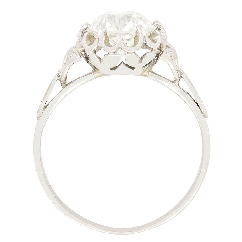 This impressive solitaire showcases a 1.70 carat diamond at its centre, The claw set old cut diamond has been given a colour of K and a Clarity of VS1. Hand made entirely in 18 carat white gold this ring simply screams Art Deco, with the geometric