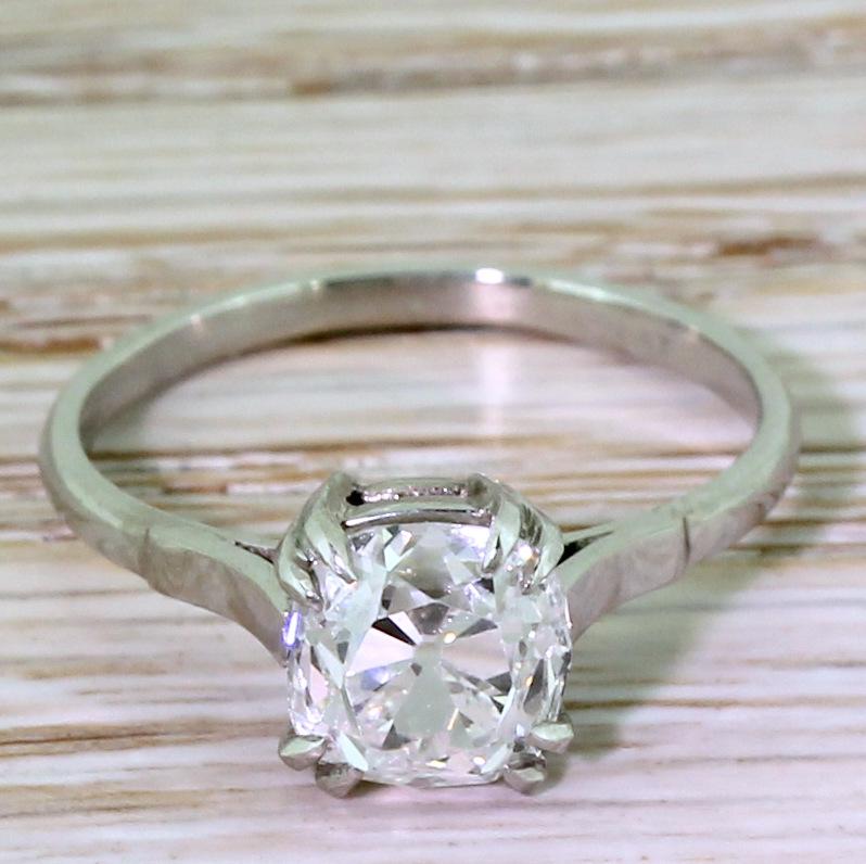One rarely finds an old cut diamond as white and as internally clean as this. Certified by GIA as F colour, VS1 clarity – the glowing cushion shaped old cut diamond is secured by four split claws in a simple, striped back setting. The mounting is