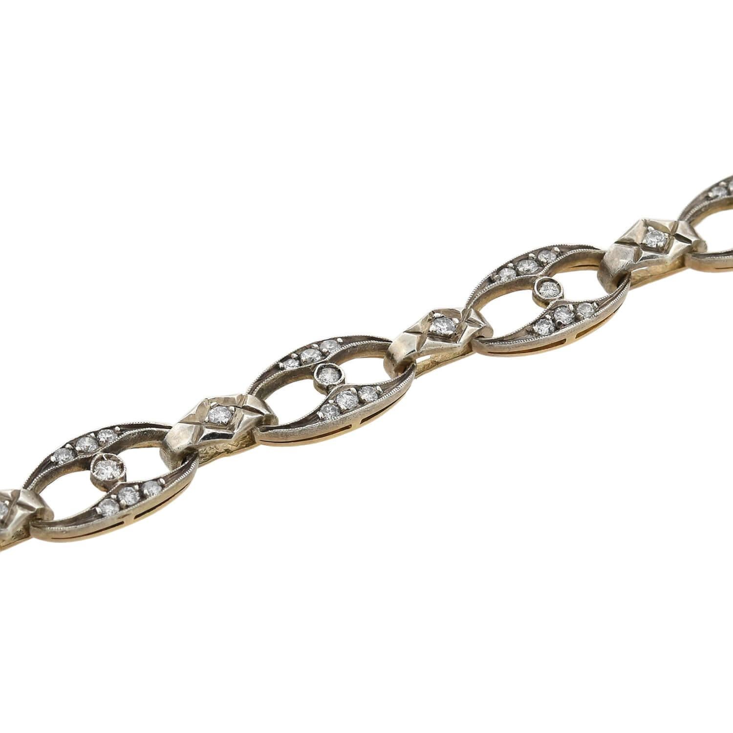 A gorgeous diamond encrusted bracelet from the Art Deco (ca1920) era! This fabulous piece is crafted in sterling topped 14kt yellow gold and features 10 oval-shaped links that alternate with diamond-shaped connector links, coming together to form a