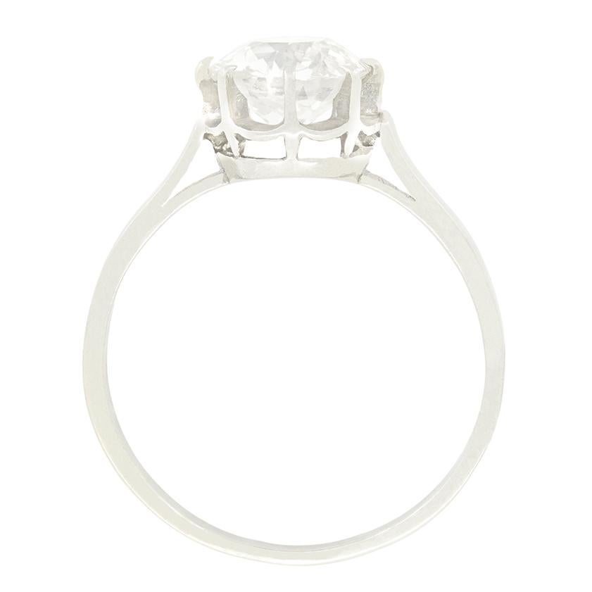 Centring around a beautiful 1.75 carat old cut diamond, this classic solitaire dates to the 1920s. The diamond has a colour of H and clarity of SI1 and is claw set into a platinum collet. True to the fashions of the Art Deco era, the collet then
