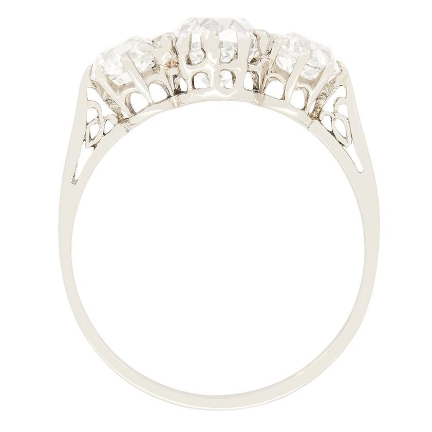 This classic Art Deco three stone ring beautifully showcases a trio of old cushion cut diamonds. The central diamonds is the largest, at 1.25 carat with the flanking pair weighing 0.50 carat a piece. All three diamonds range in colour from G to H