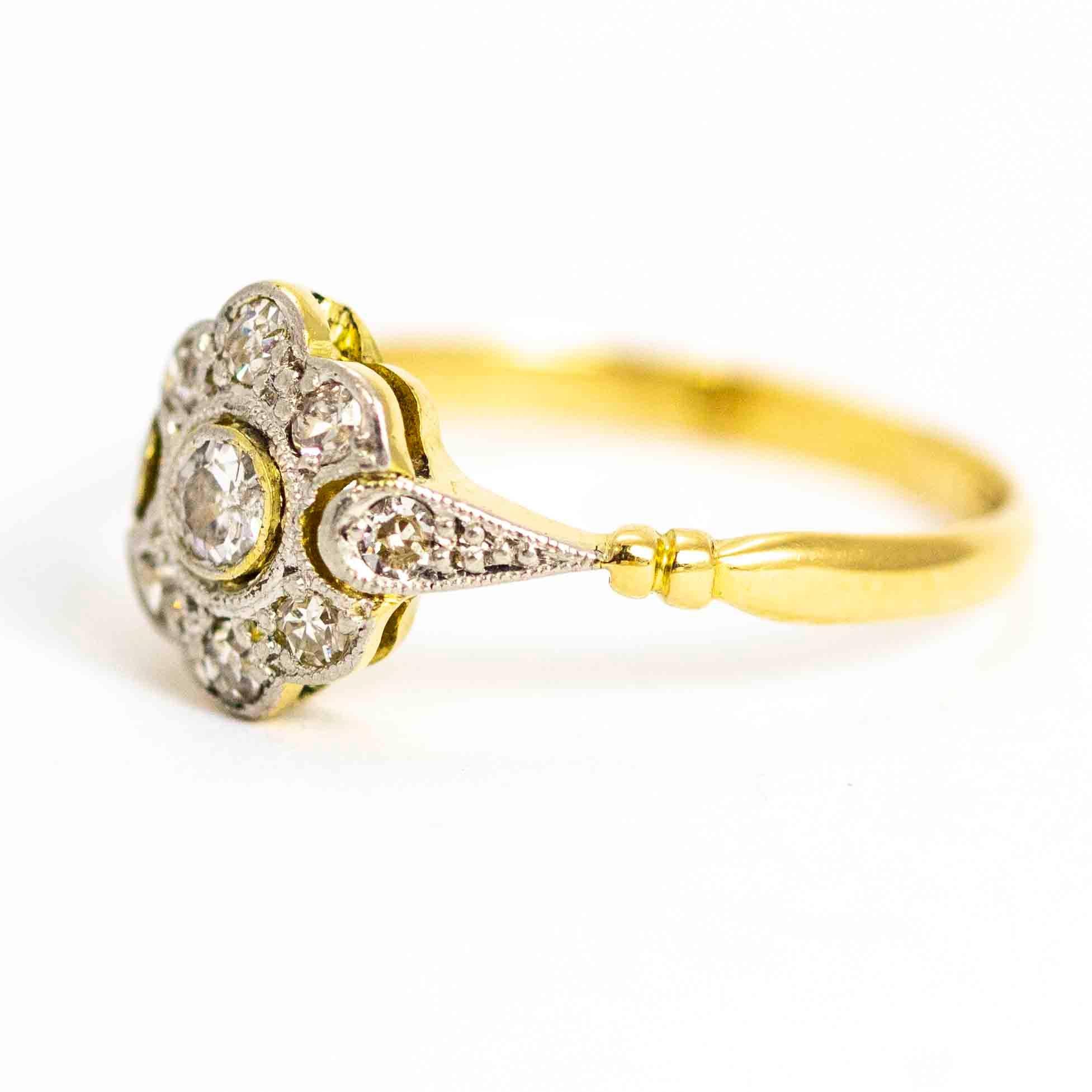 An exquisite Art Deco cluster ring. The cluster is beautifully designed in platinum to complement the white diamonds. The central old European cut stone measures approximately 10 points. This sits between the elegant teardrop shoulders which are