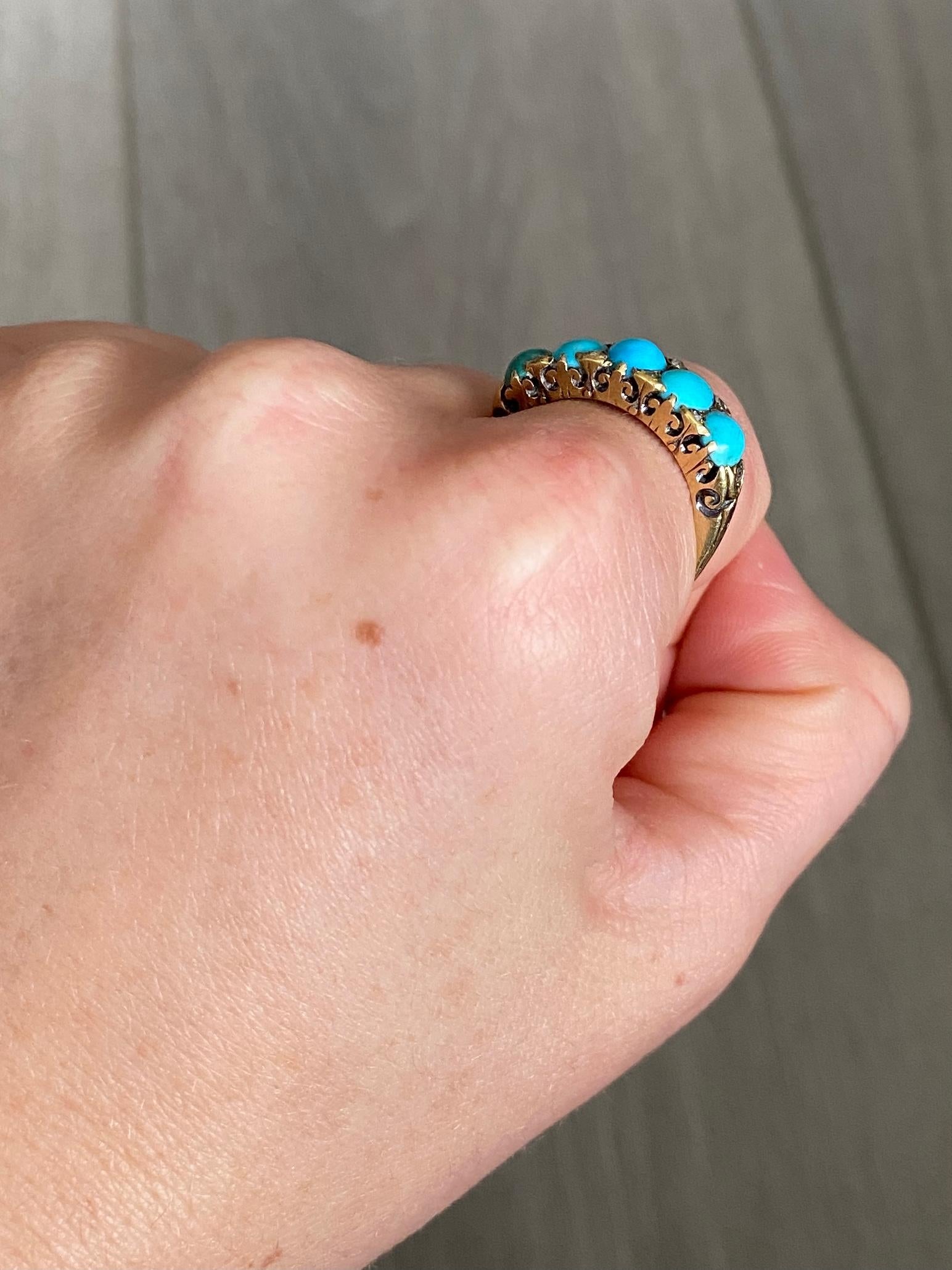 A spectacular vintage five-stone ring. Set with five wonderful cabochon cut turquoise with diamonds points in between. Modelled in 18 carat yellow gold.

Ring Size: O or 7 1/4 
Band Width: 7mm
Height Off Finger: 5mm

Weight: 4.9