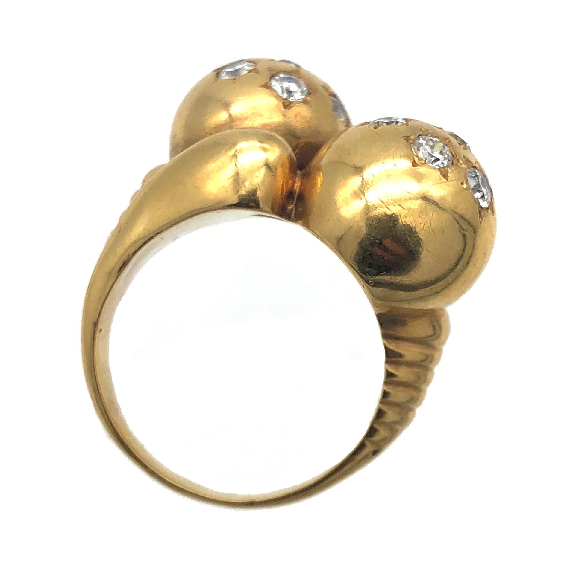 Stylish and elegant mid 1930's ring with a partially ribbed shank holding two diamond set balls. Each ball is decorated with seven diamonds and mounted in star shaped settings. 