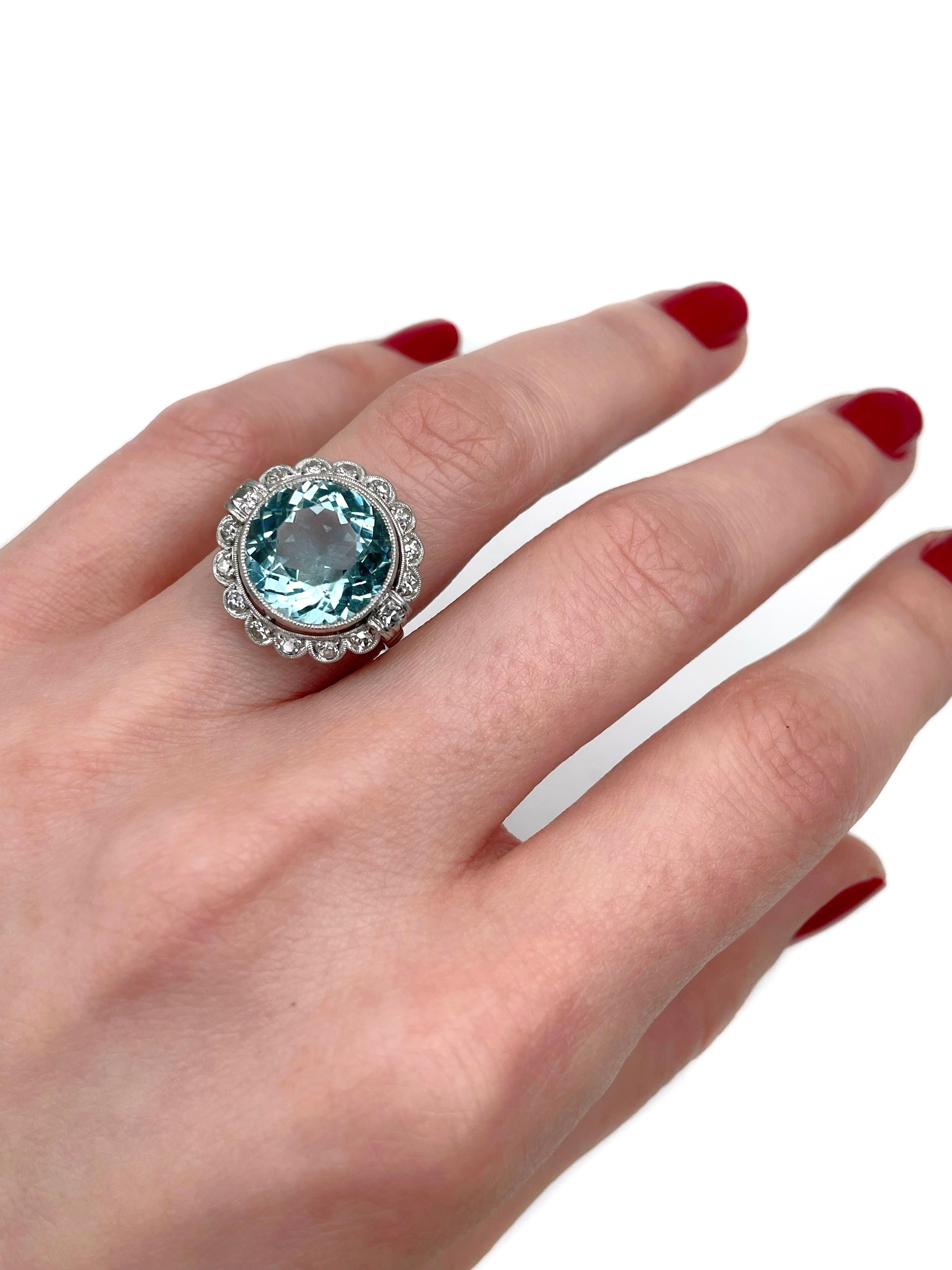 This is a lovely Art Deco cluster ring crafted in 18K white gold. Circa 1930. 

The piece features:
- 1 aquamarine, round cut, 6.00ct, gB 2/2, VVS
- 16 diamonds, round brilliant cut, TW 0.35ct, RW-W, VS-SI

Weight: 5.04g
Size: 16.25 (US