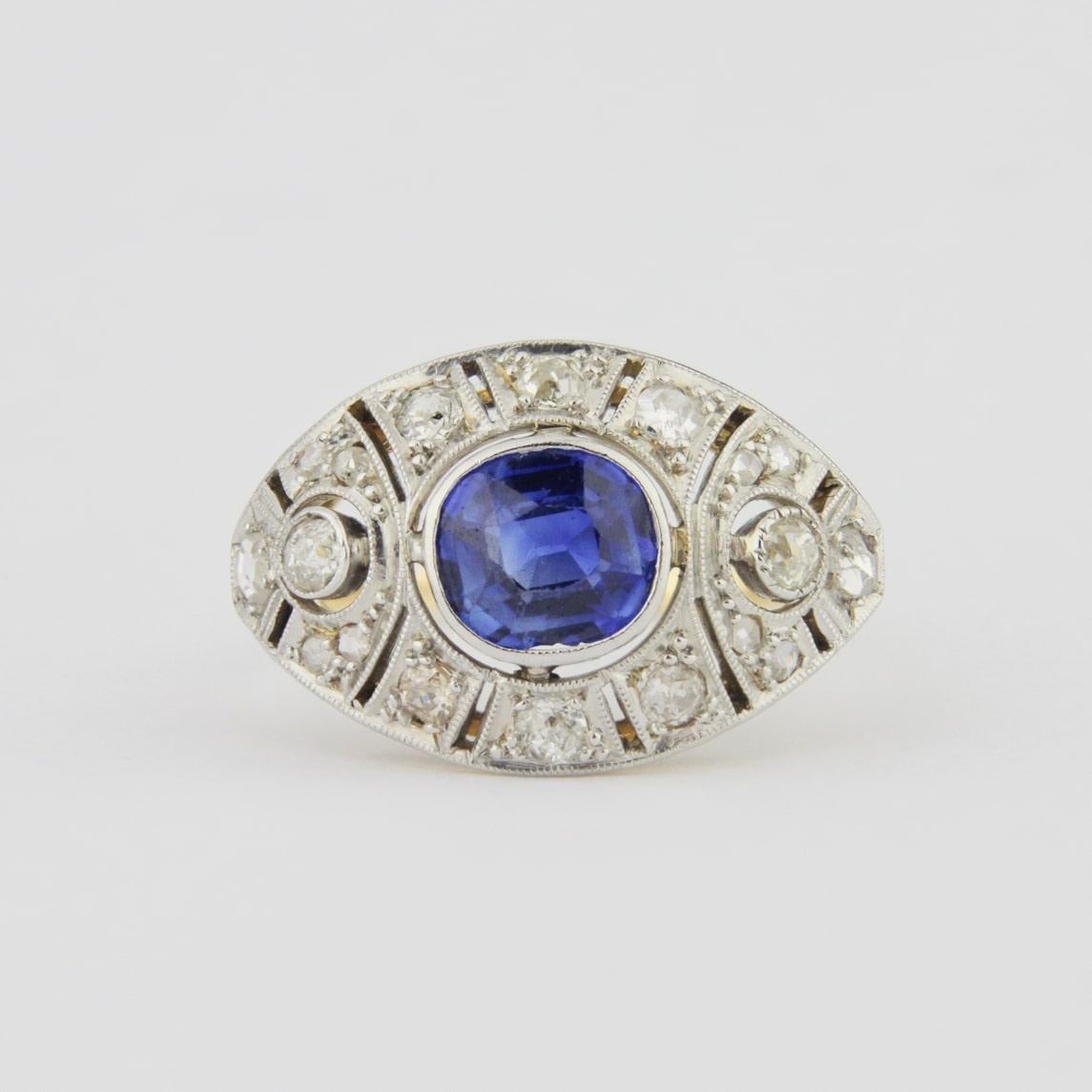 An original Art Deco ring with diamonds and a central Ceylon sapphire set in 18 karat gold. This impressive ring likely dates to the 1930s and whilst unmarked has been tested as 18 karat gold. The central cushion cut Ceylon sapphire weighs 1.25