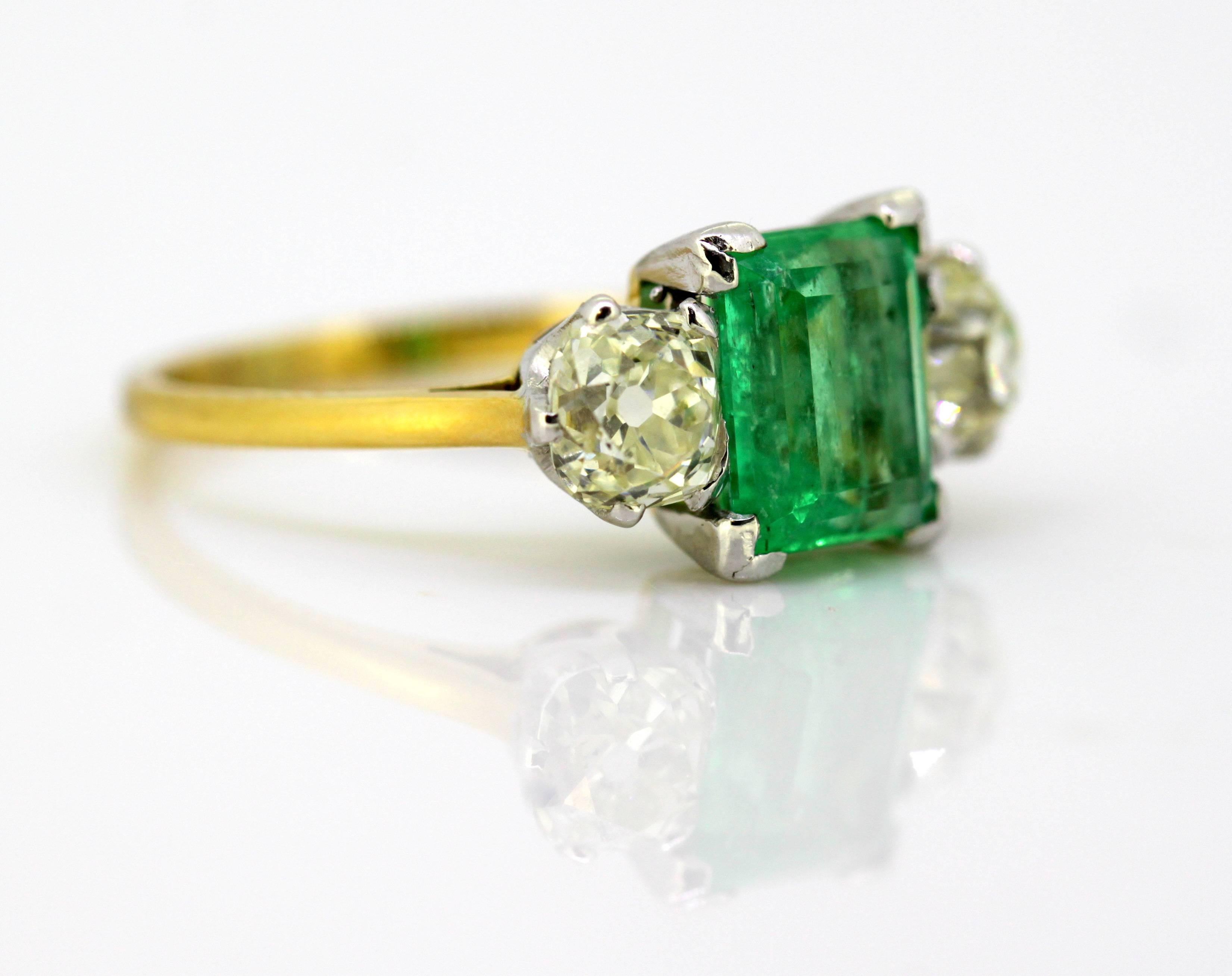 Art Deco 18K Gold Three Stone Ladies Ring With Emerald & Diamonds
Circa.1920's

Dimensions -
Finger Size: (UK) = M (US) = 6 1/2 (EU) = 52 1/2
Weight: 4 g
Ring Size : 2.4 x 2 x 0.9 cm

Emerald - 
Cut : Emerald
Size : 1 CT
Treatment : Natural

Diamond