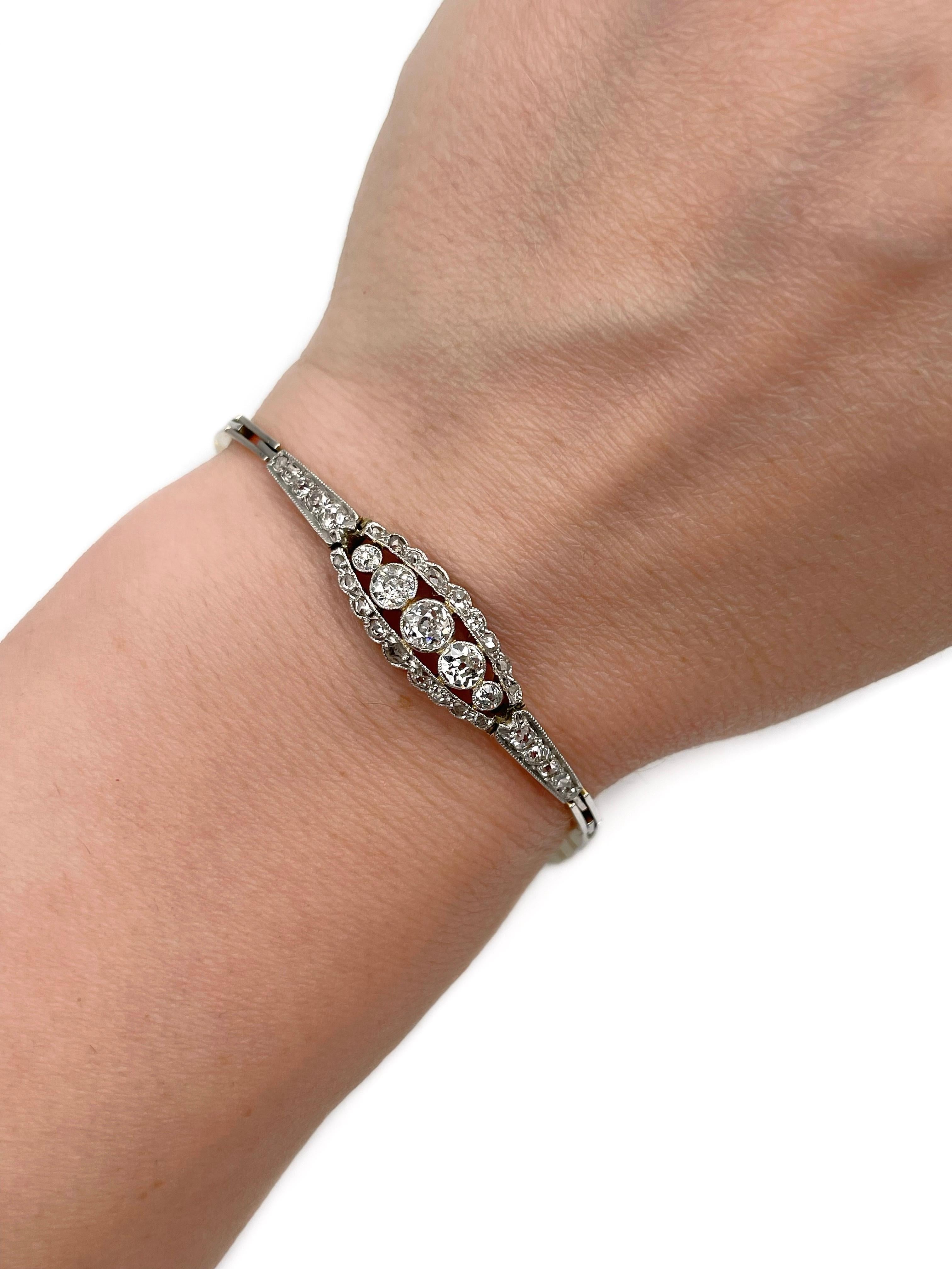 This is an elegant Art Deco link bracelet crafted in 18K gold and 950 platinum. Safety chain is 830 silver. Circa 1930.

The piece features diamonds (TW 0.87ct): 
- 15 diamonds, old cut, TW 0.65ct, RW+/W, SI-P2
- 20 diamonds, irregular/rose cut, TW