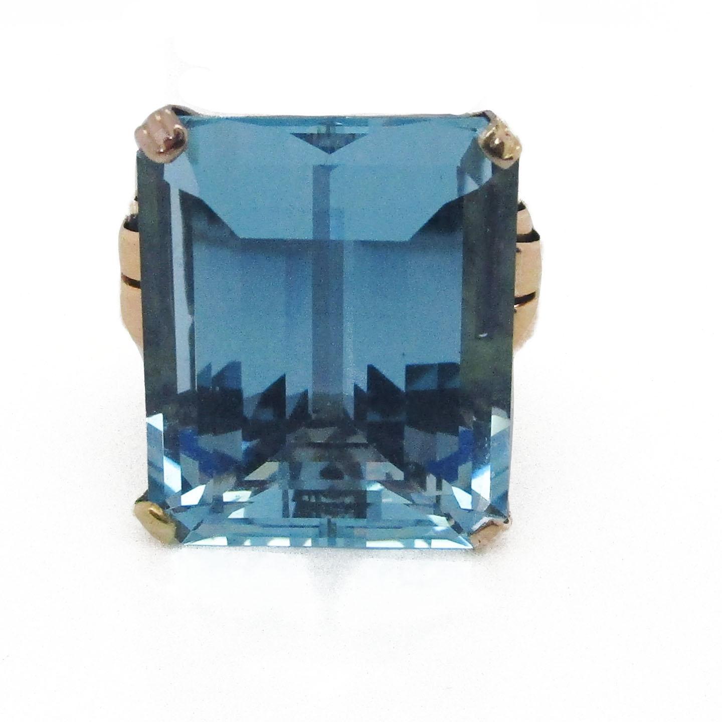 This absolute stunner of an Art Deco ring is from 1935 and features a killer combination of 18k rose gold and a knockout 28 + carat aquamarine center! The stone has gorgeous soft blue hues and an enchanting element of dimensionality which means you