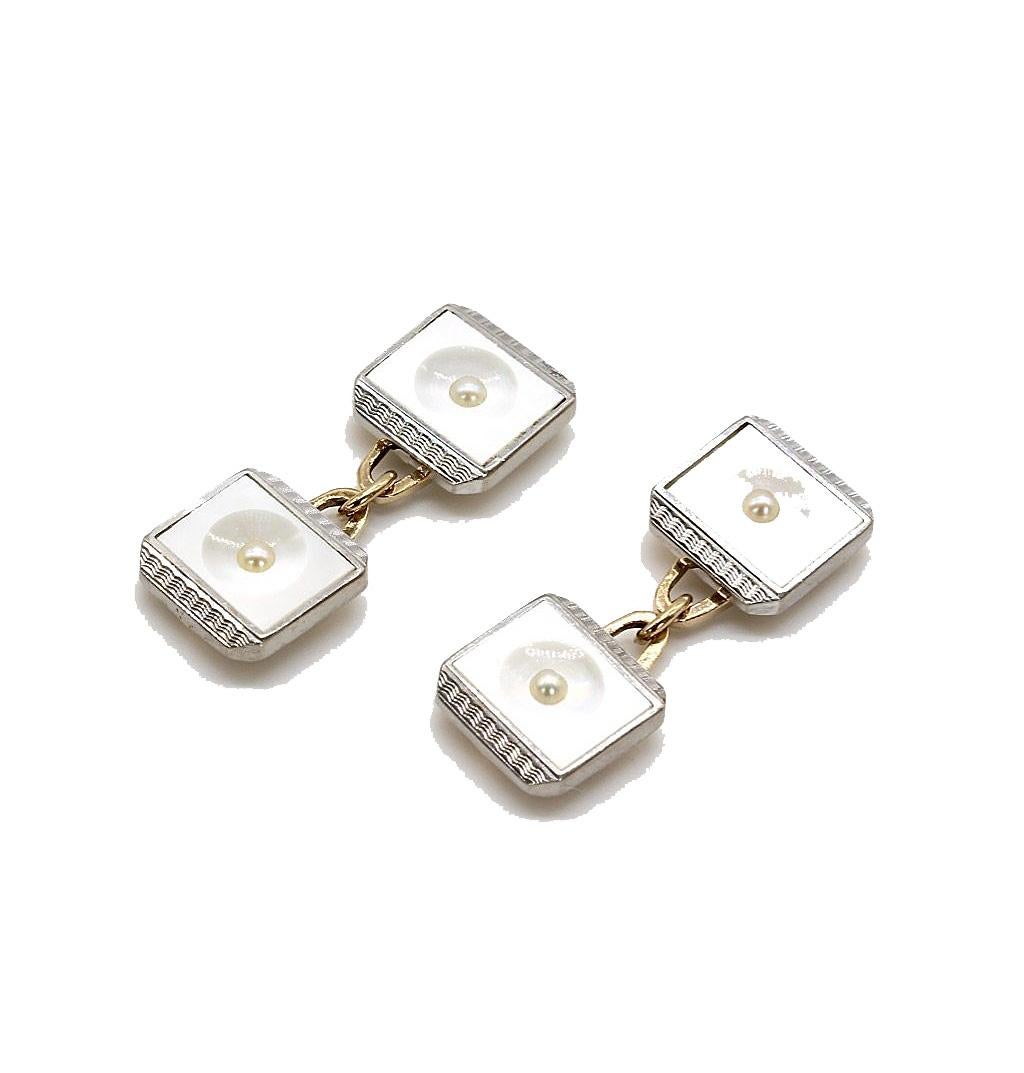 An Art Deco 18 kt white gold and 9 karat yellow gold Gentleman's cufflink and button tuxedo dress set. The square mother of pearl links with 18 kt engine turned white gold to the side and a central seed pearl. The set comprising a pair of chain