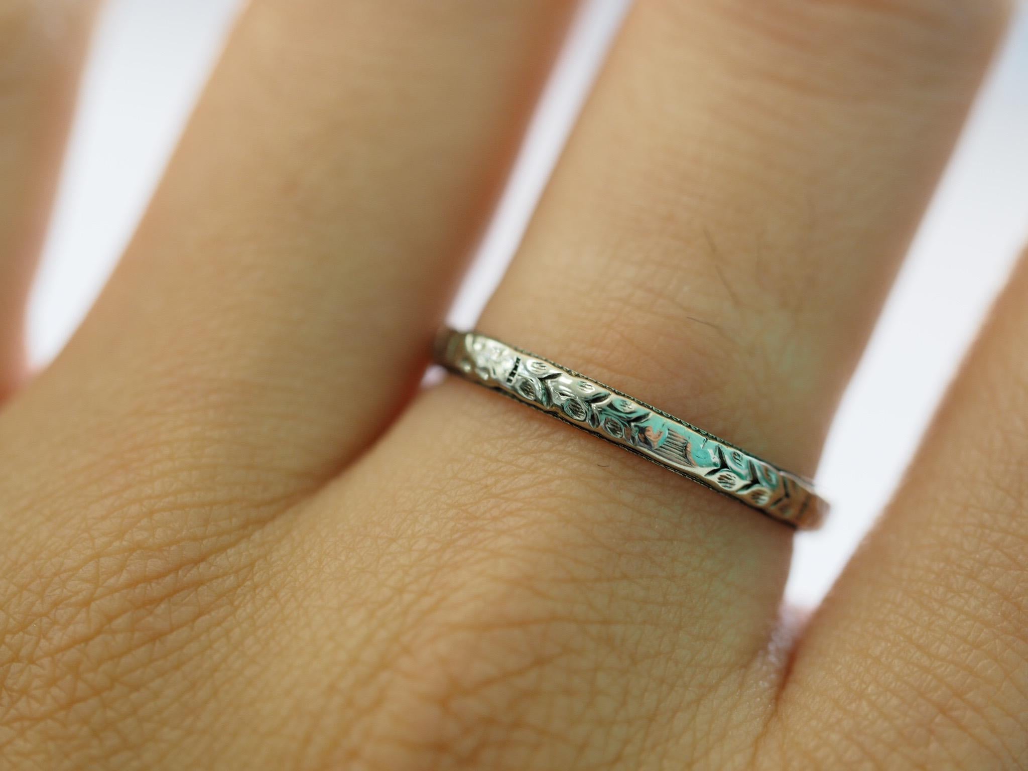 This Art Deco 18 Karat White Gold Band dates back to the 1920's.  It has beautiful engraving all the way around. 2 Grams. Size 7.5 can be sized upon request prior to shipping at no charge. 

Metal: 18K White Gold
Width: 2.34mm
Thickness: 1.24mm