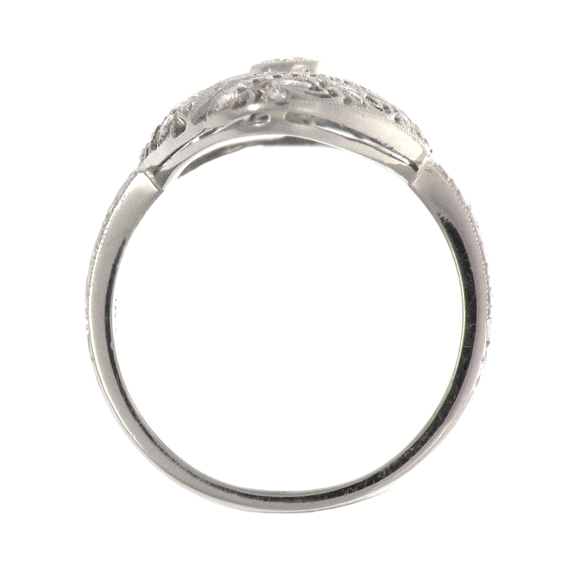 This delicate, hand crafted 18 carat white gold ring has pierced open work and is diamond encrusted which perfectly compliments the central 0.08 ct diamond plus 0.34 ct of smaller stones. The filigree work on this piece is absolutely magnificent.