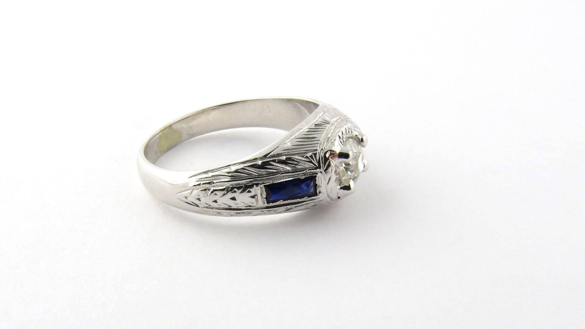 Vintage Art Deco 18K White Gold Old Mine Diamond and Sapphire Ring Size 7.25 

This art deco diamond ring is set with a center old mine round diamond .40 carats. SI2 clarity, J-K color 

The rectangular milgrain set genuine blue sapphires are each