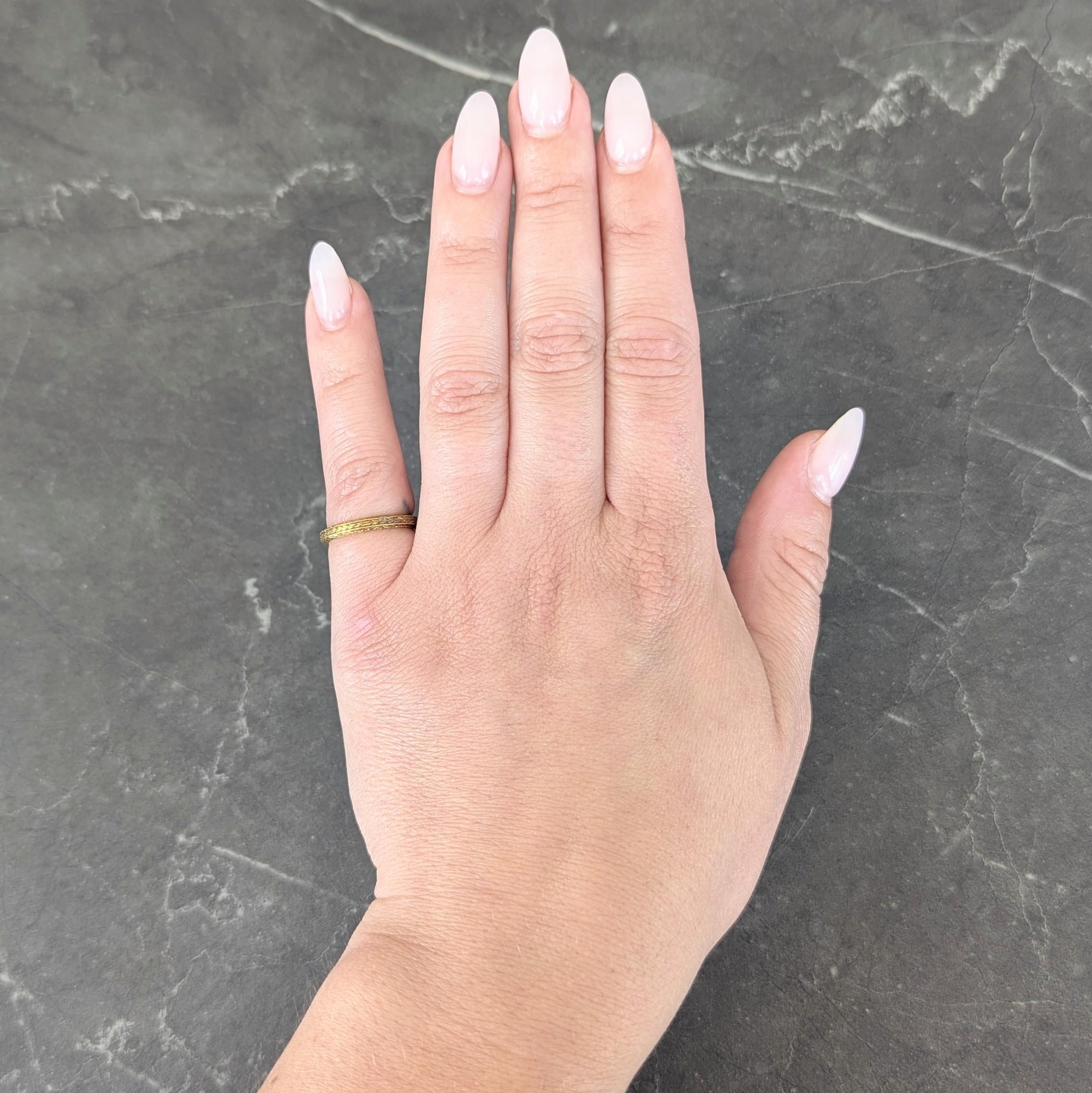 Featuring an engraved wheat motif fully around
With engraved wheat motif profile
Stamped for 18 karat gold
Circa: 1930s
Ring Size: 4 1/4 and sizable
Measures north to south 2.5 mm and sits 1.5 mm high
Total Weight: 2.6 grams
Stock Number: We-14846