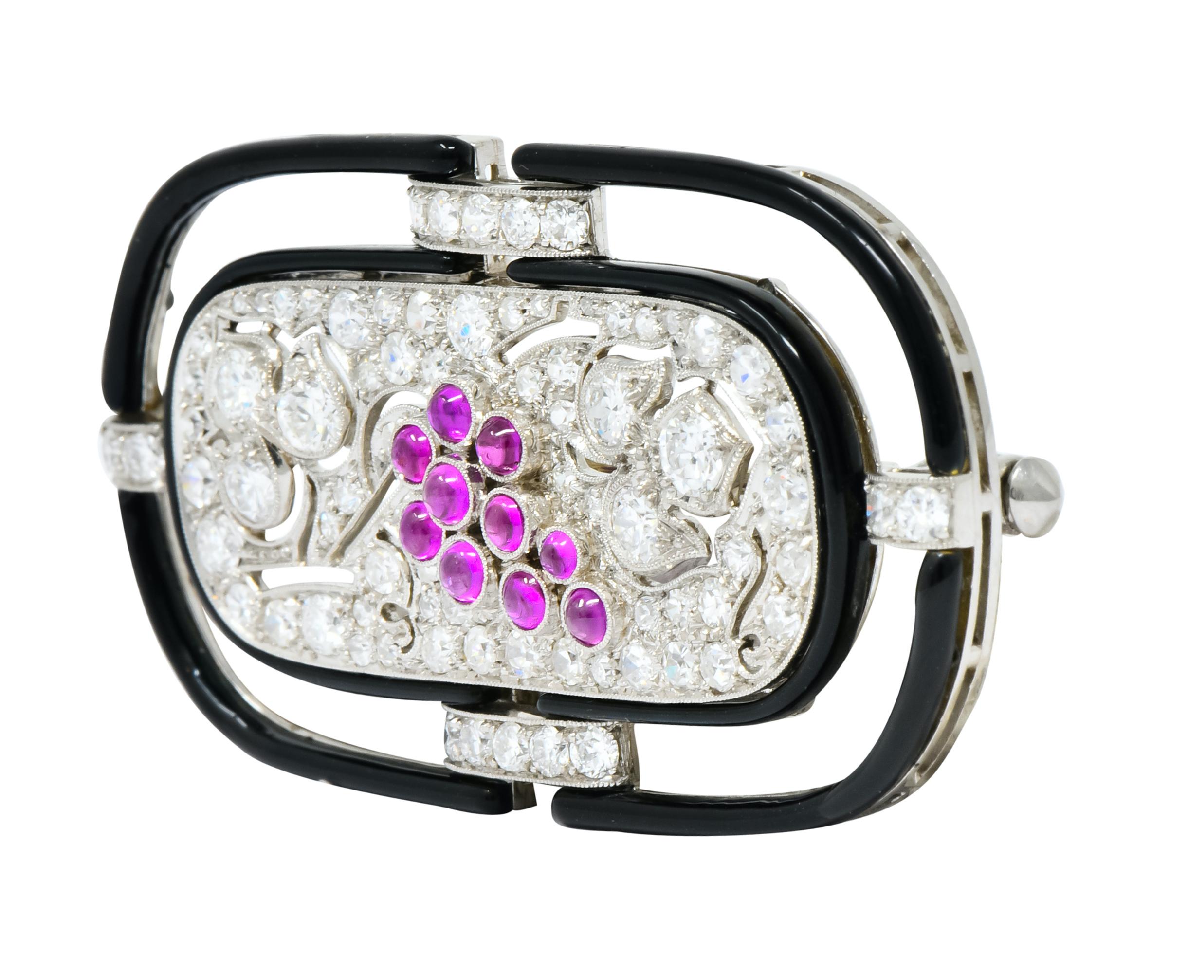 Designed as an oblong platinum brooch featuring round brilliant cut diamonds bead set throughout, weighing approximately 1.80 carats total, E/F color and VS clarity

With 10 bezel set ruby cabochons in a grape cluster motif, deep pinkish hue and