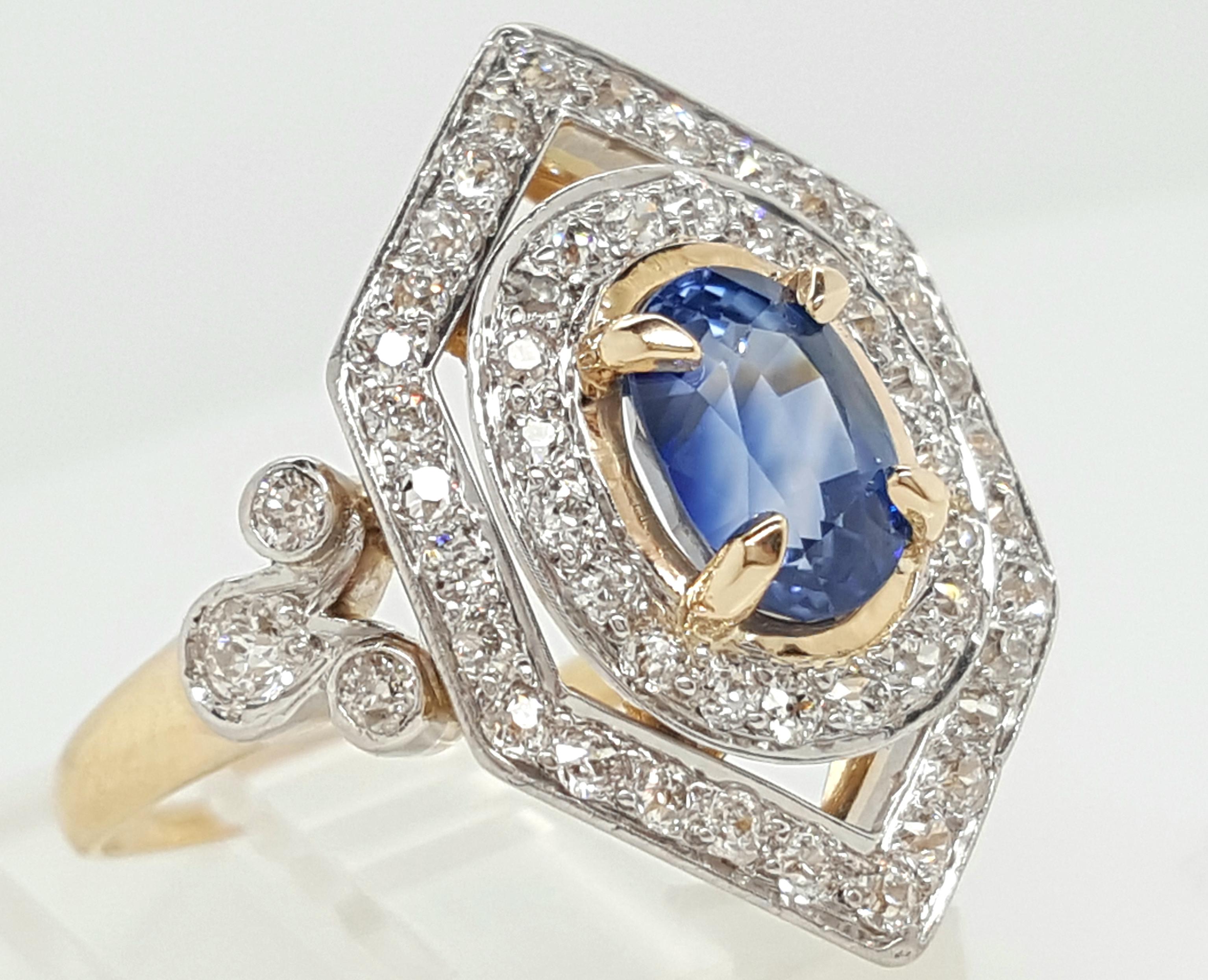 Here we have a stunning diamond and sapphire Art Deco era cocktail ring. The 18K Yellow Gold band has an intricate filigree and an etched design that accents the diamonds and deep blue sapphire gorgeously, taking this beauty to the next level. This