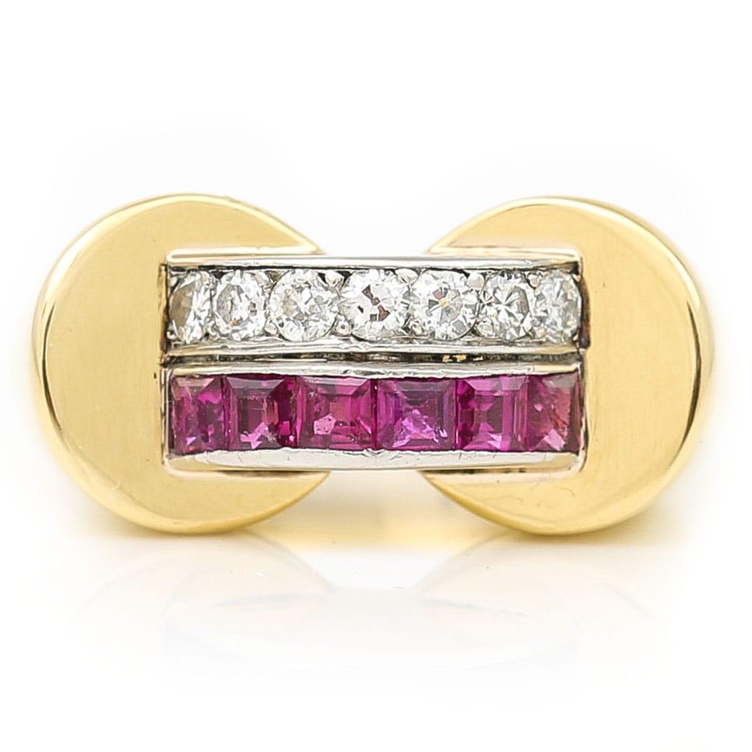 A fabulous French Art Deco 18ct yellow gold ruby and diamond tank ring dating from circa 1940. The statement ring has a central bridge which connects either side of the shank and is set with 7 old cut diamonds totalling approx 0.30ct and a further 6