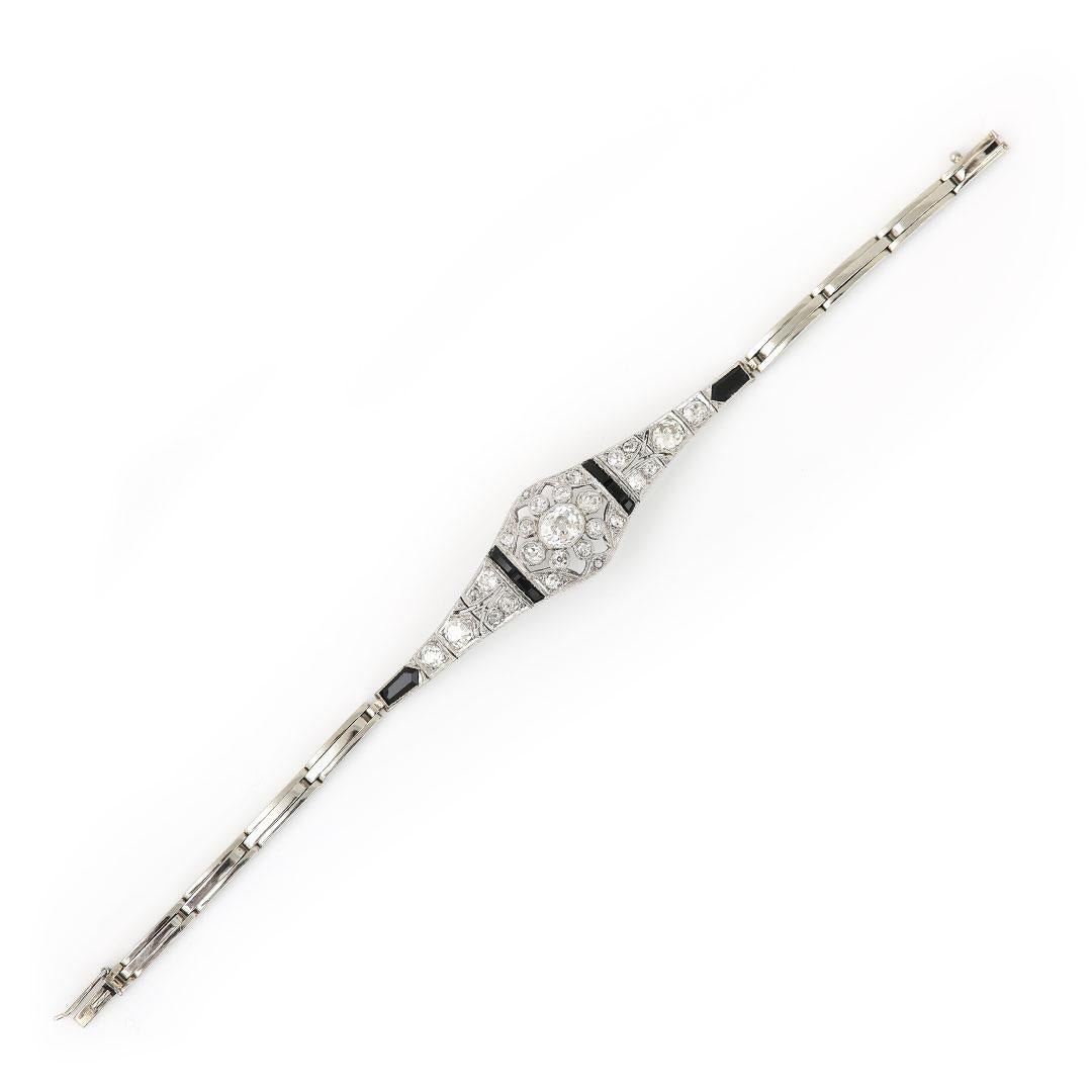 A stunning, original Art Deco 18ct white gold, old mine cut diamond and onyx bracelet masterfully crafted during the height of the 1930s. The design is so archetypal of the period, with plenty of geometry and symmetry which makes these pieces so