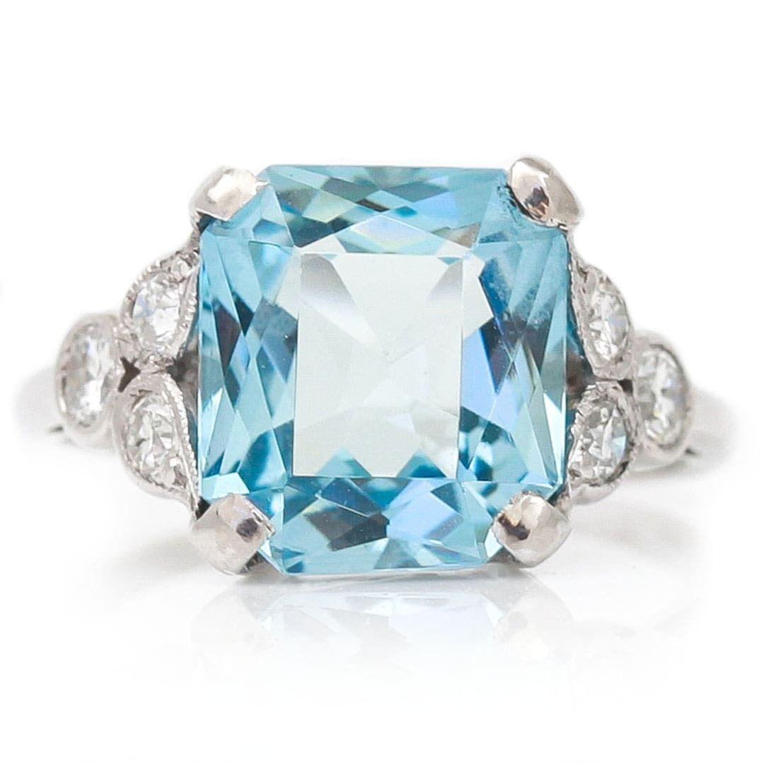 A stunning, original Art Deco 3.40ct aquamarine and 0.40ct diamond ring set in 18ct white gold and platinum. This super antique ring has a central set deep blue fancy, square cut aquamarine with attractive diamond set shoulders; these are millegrain