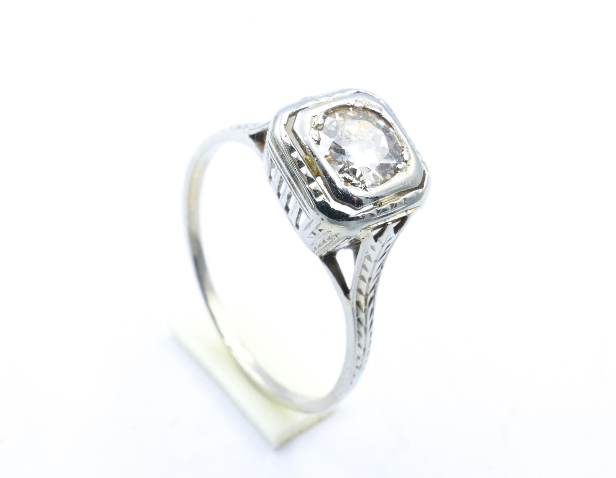 This gorgeous Art Deco Ring, Circa 1925, really has quite a large Diamond of nearly half a carat as its centrepiece.
It is bead set in 18ct White Gold with feathered engraving on the shoulders.
The Diamond is a good quality J and really does quite