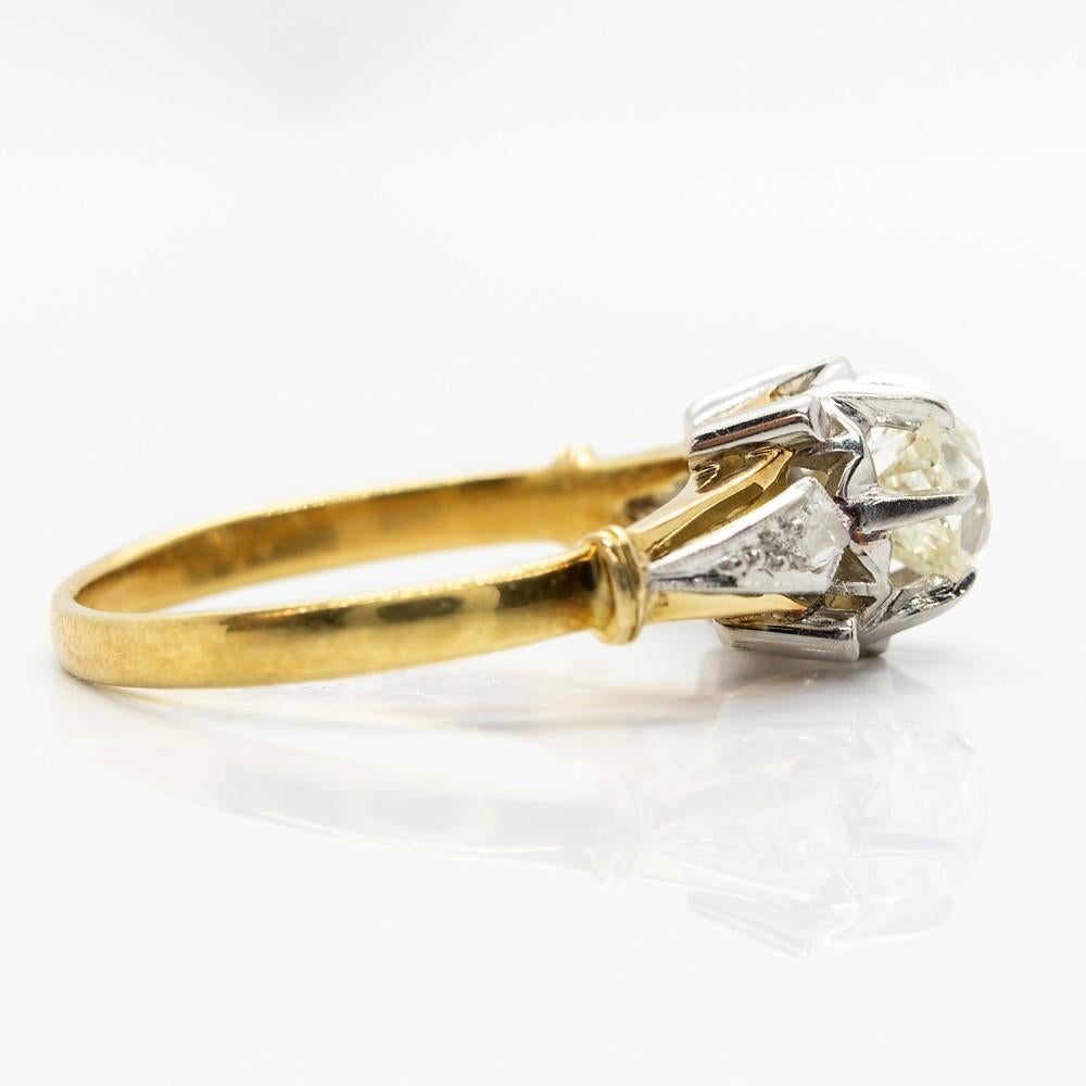 Composition: 18k gold and platinum 
Period:  Art Deco 
•	1 old mine cut diamond J-VVS1 0.70ctw.
•	2 old mine cut diamonds  J-SI1 0.15ctw.
Ring size: 7 ½ 
Ring face: 14mm by 8mm by 8mm
Total weight: 3.7 grams - 2.4dwt
