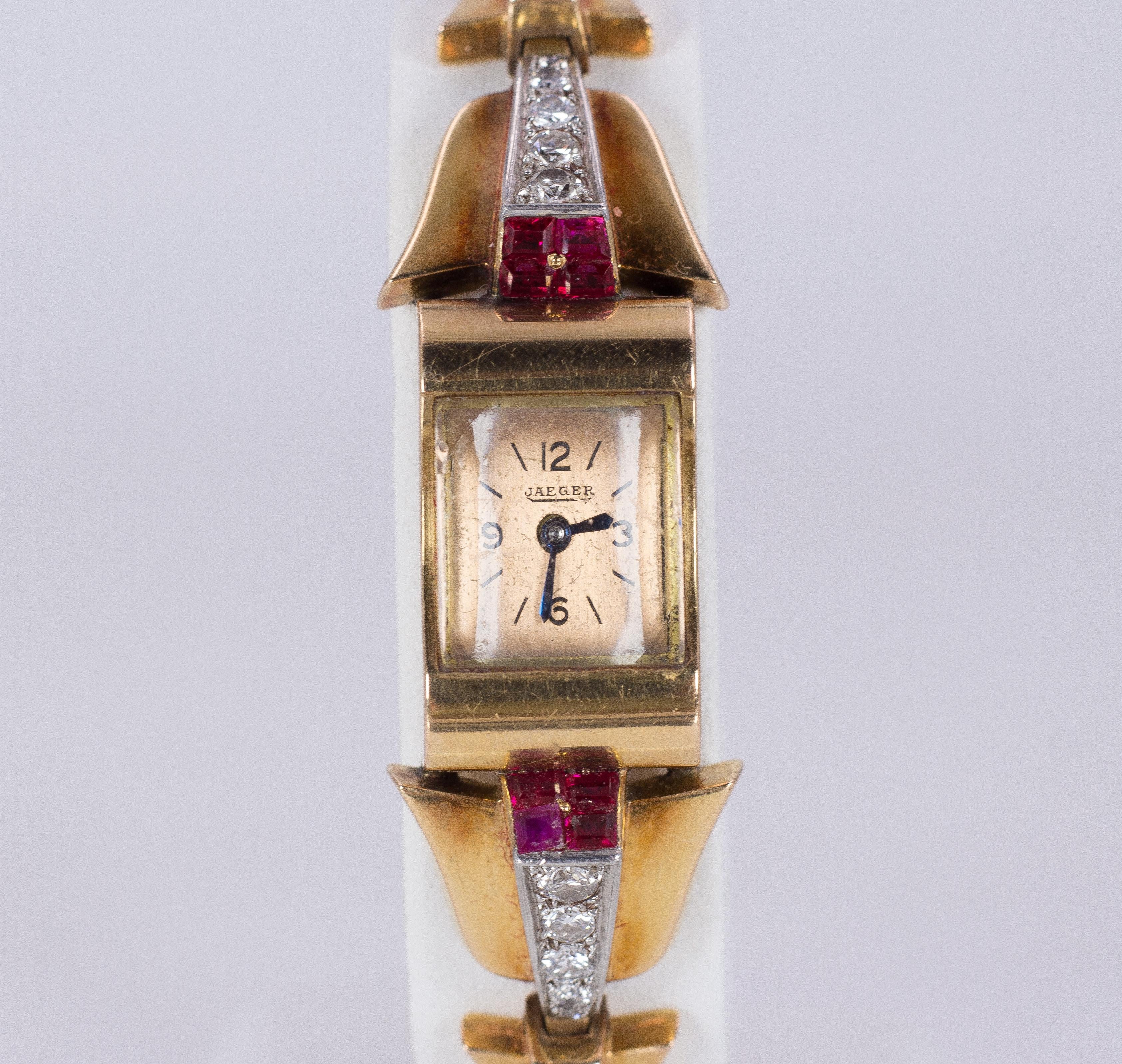 A stunning and precious antique wristwatch, dating from the Art Deco period (1930s), branded Jaeger. 
This lady watch is both a watch and a jewel: it has a rectangular 18K solid gold dial and it is set with a beautiful bracelet, crafted in 18K solid