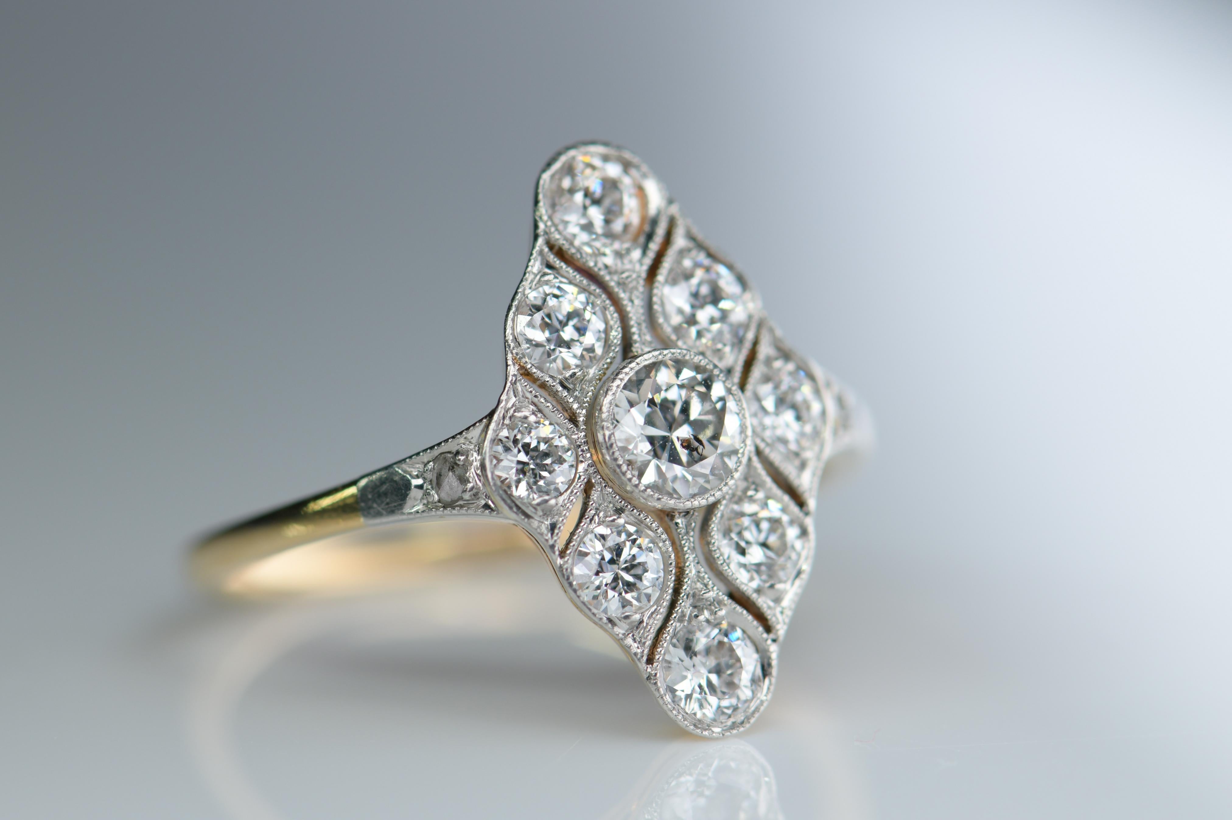 Dandelion Antiques Code: AT-0608

An unusual Art Deco ring that was made circa 1920. The shank is 18ct white gold with a platinum top. It is a neat design with a band of diamonds crossing the rhombus shape section on to the shoulders. The diamonds